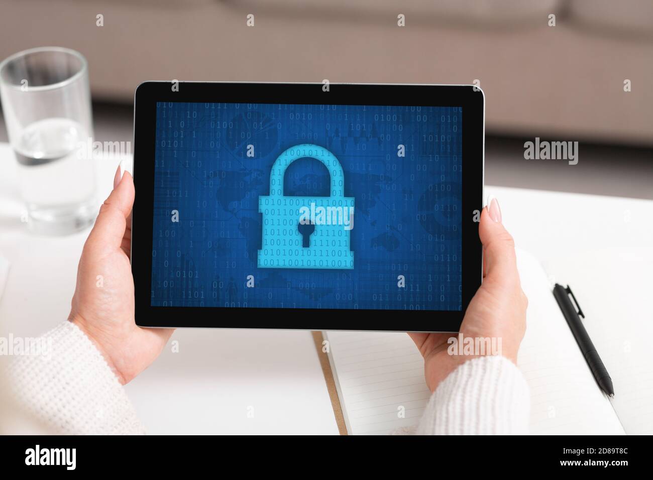 Woman using tablet, padlock icon on the screen Stock Photo