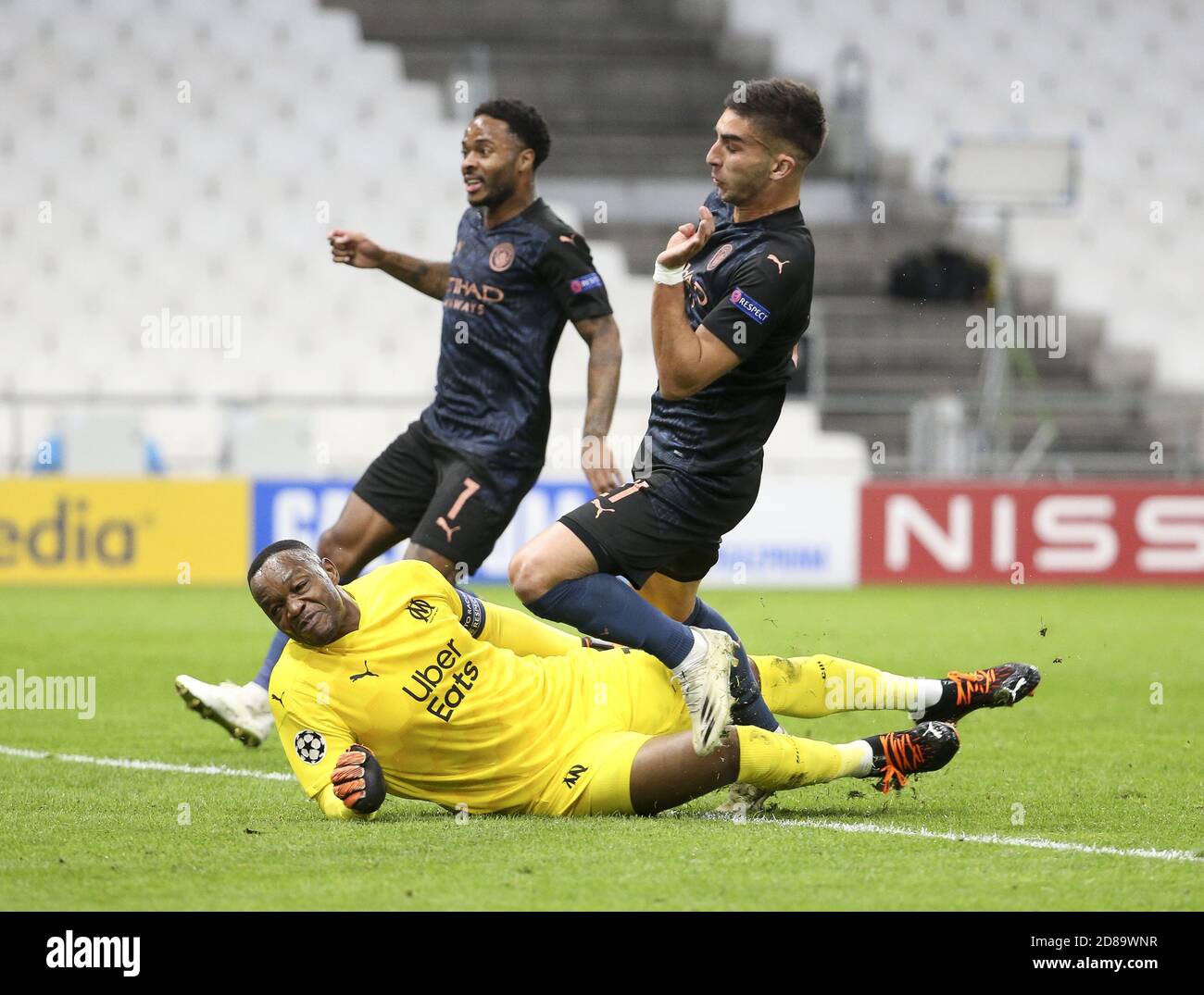 Ferran Torres of Manchester City scores the first goal against goalkeeper of Marseille Steve Mandanda while Raheem Sterling of Manchester City (left C Stock Photo