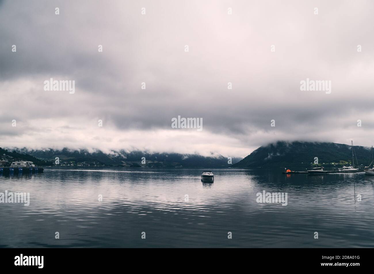 Lake with mountain forest background under cloudy sky Stock Photo - Alamy