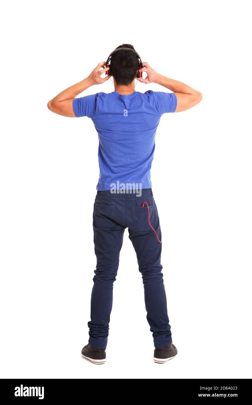 Full length portrait from behind of a man wearing headphones to listen  music over white background Stock Photo - Alamy