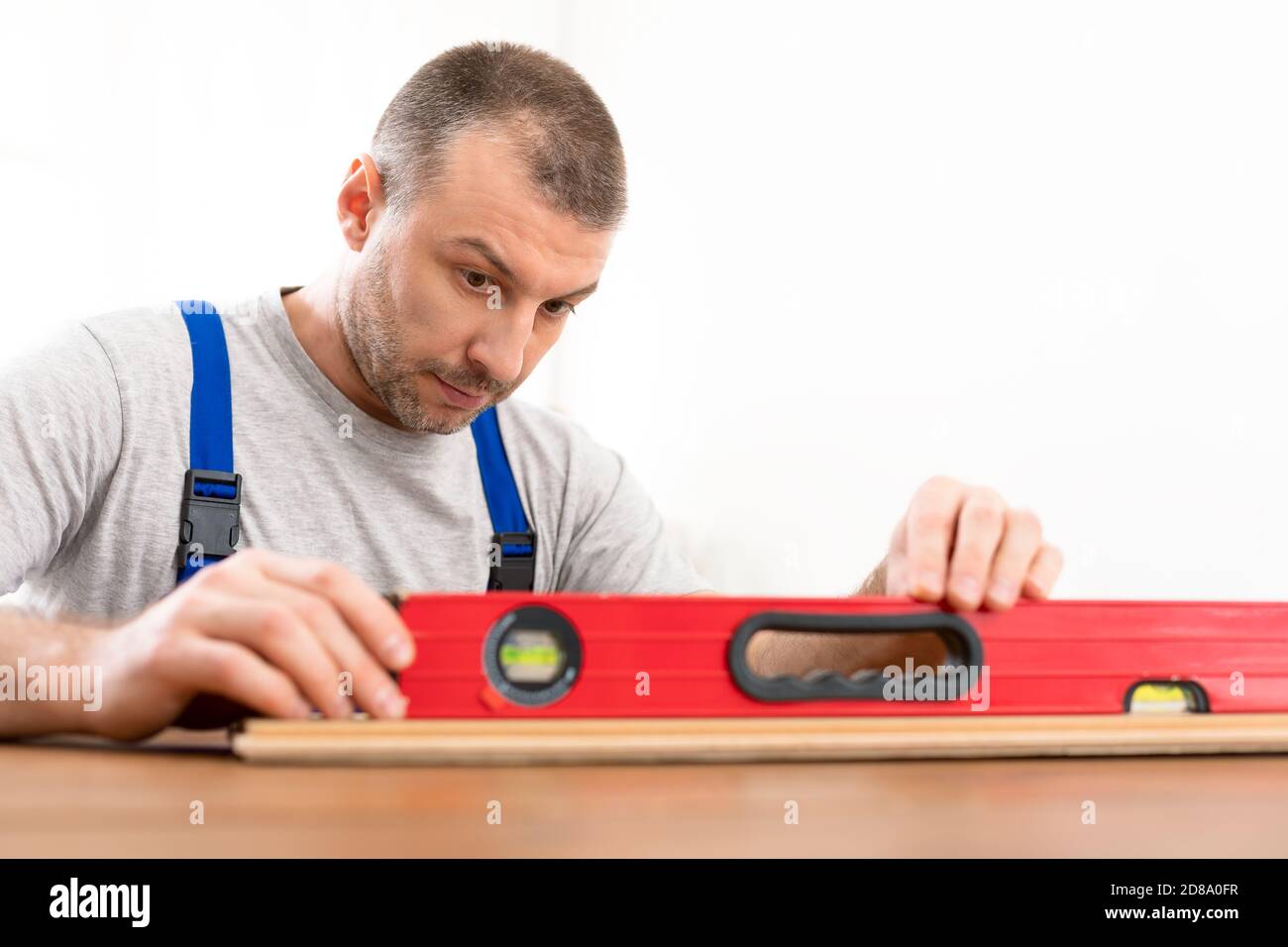 Carpenter Using Carpentry Level Tool Making Shelf Indoors Stock Photo