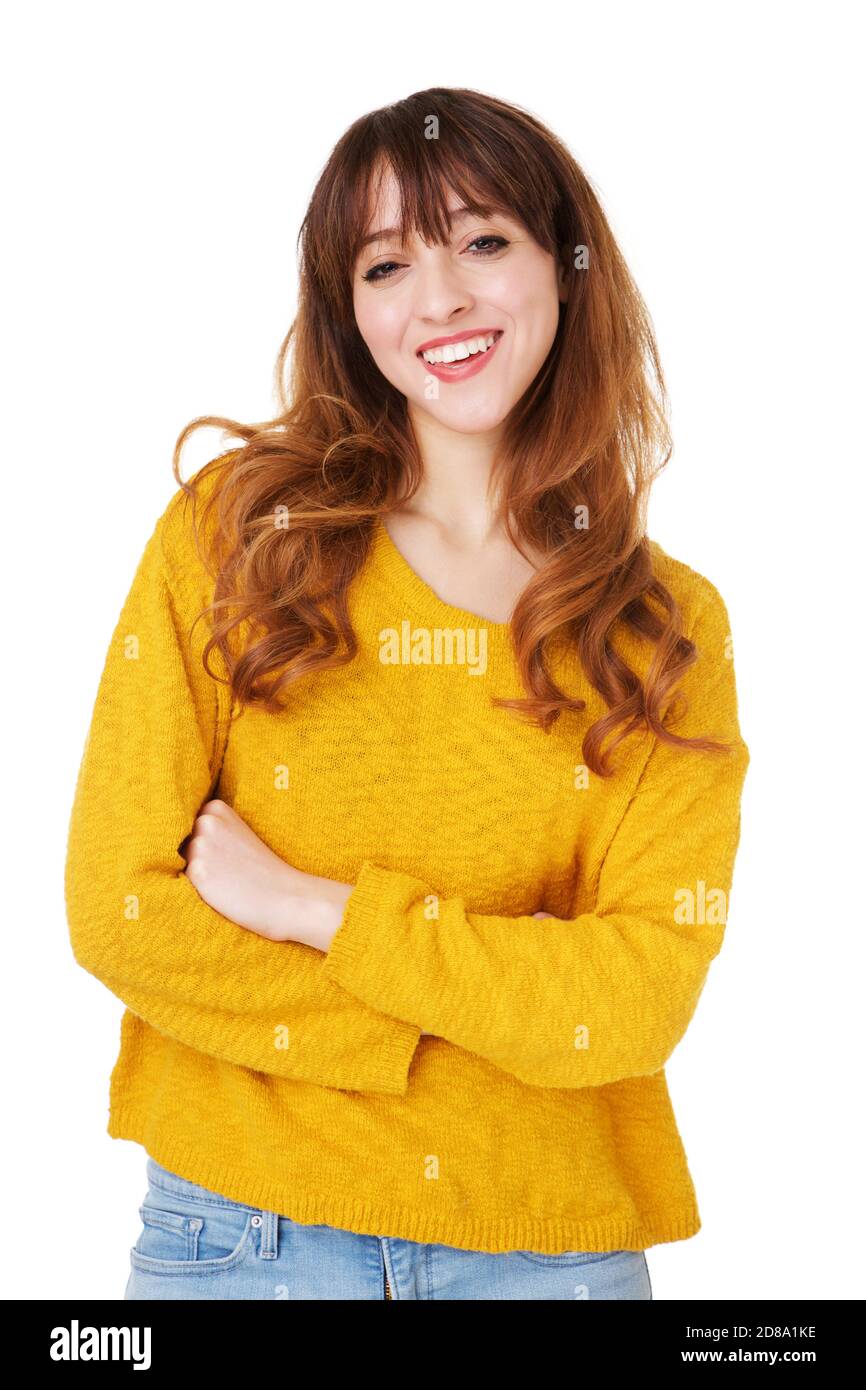 Portrait of young woman smiling with arms crossed against isolated ...