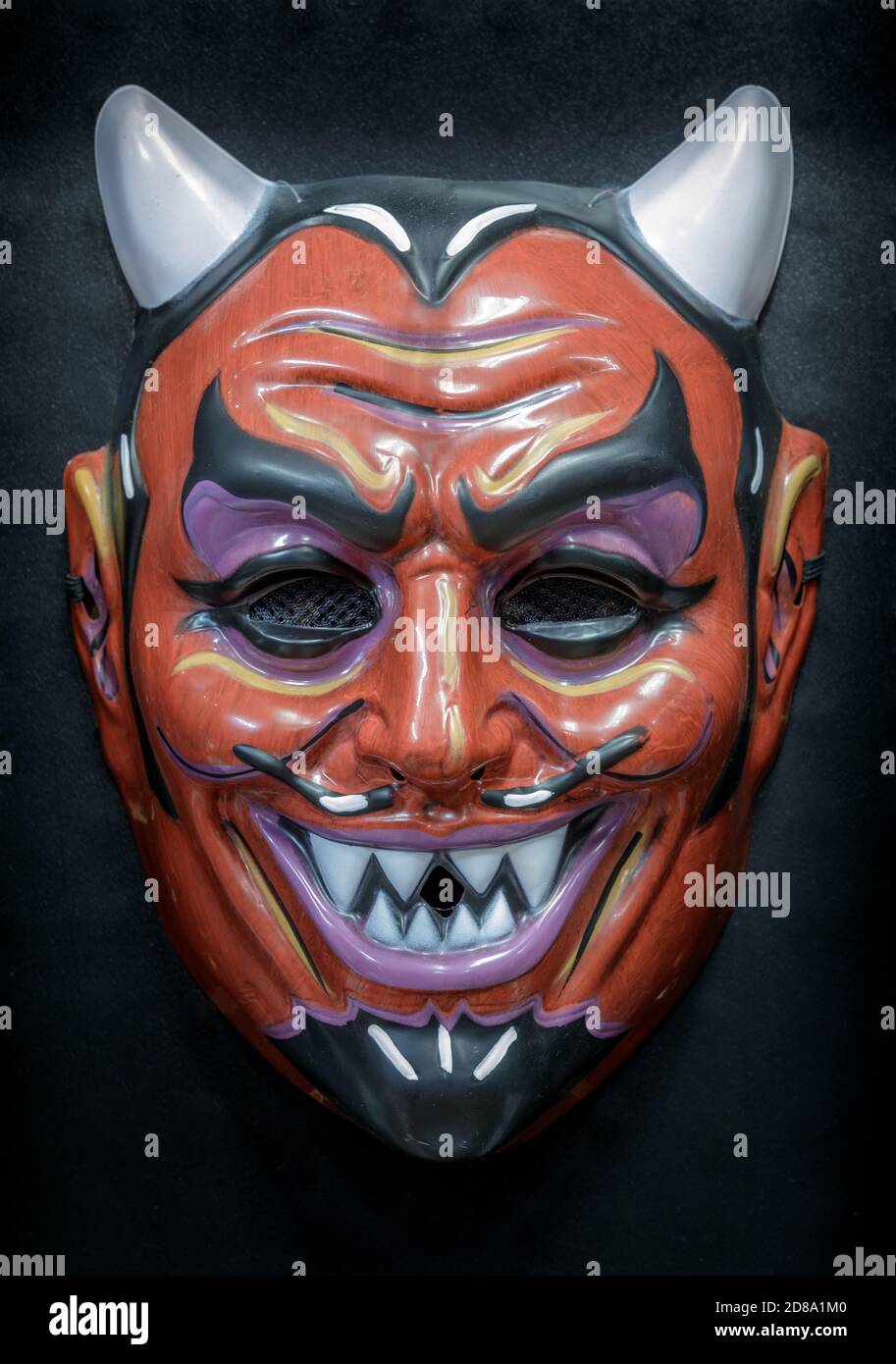Vintage Devil Face Mask Isolated Against Black Background Stock Photo