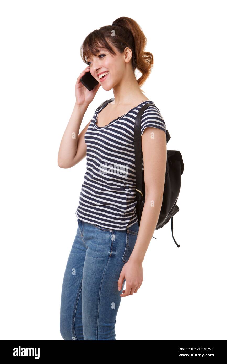 Side portrait of young woman with mobile phone and bag against white background Stock Photo