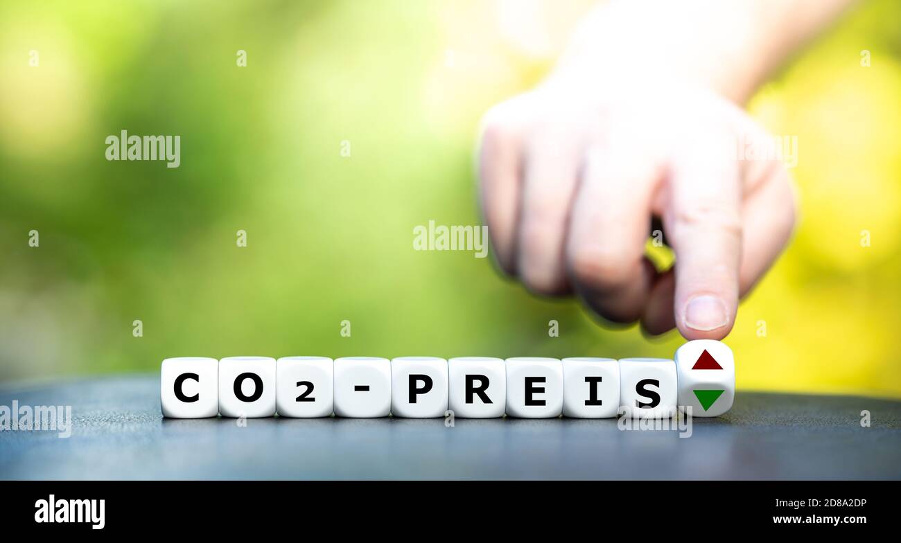 Symbol for an increasing CO2 price. Dice form the German expression 'CO2-Preis' (CO2-price). Stock Photo