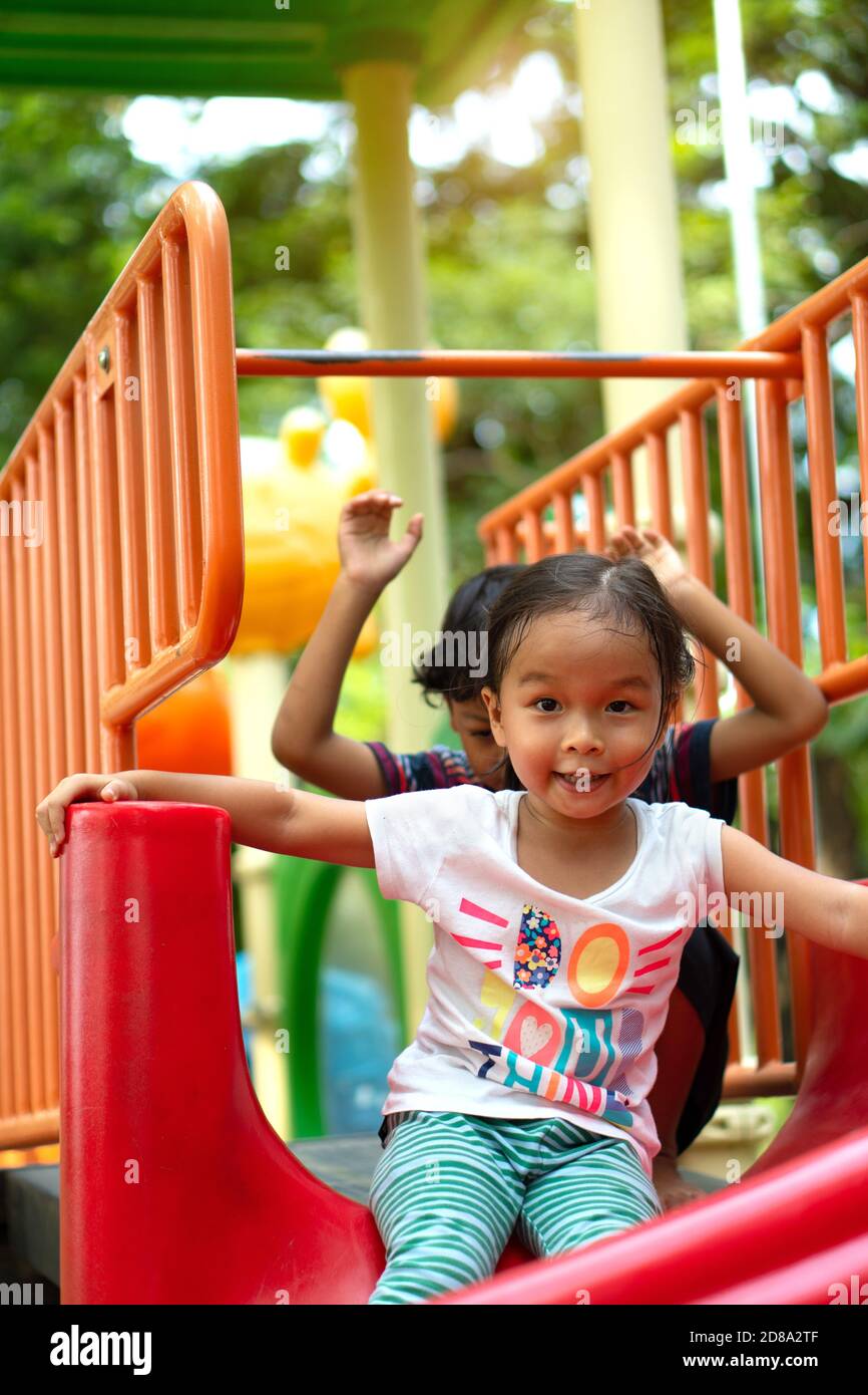 Four children playing in a playground - Stock Image - F033/7416 - Science  Photo Library