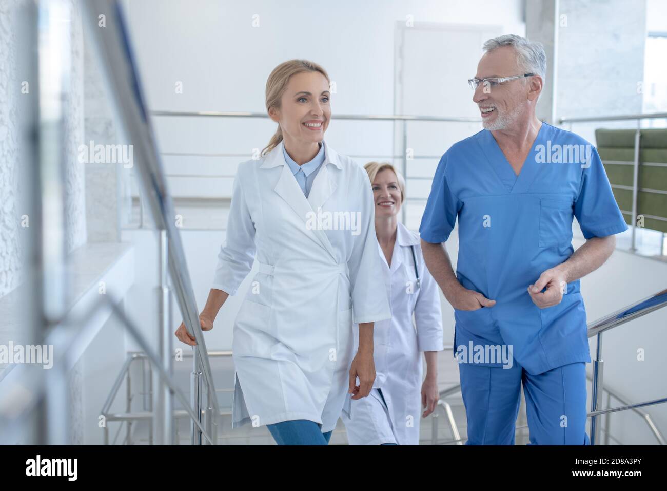 Group happy doctors discussing hi-res stock photography and images - Alamy