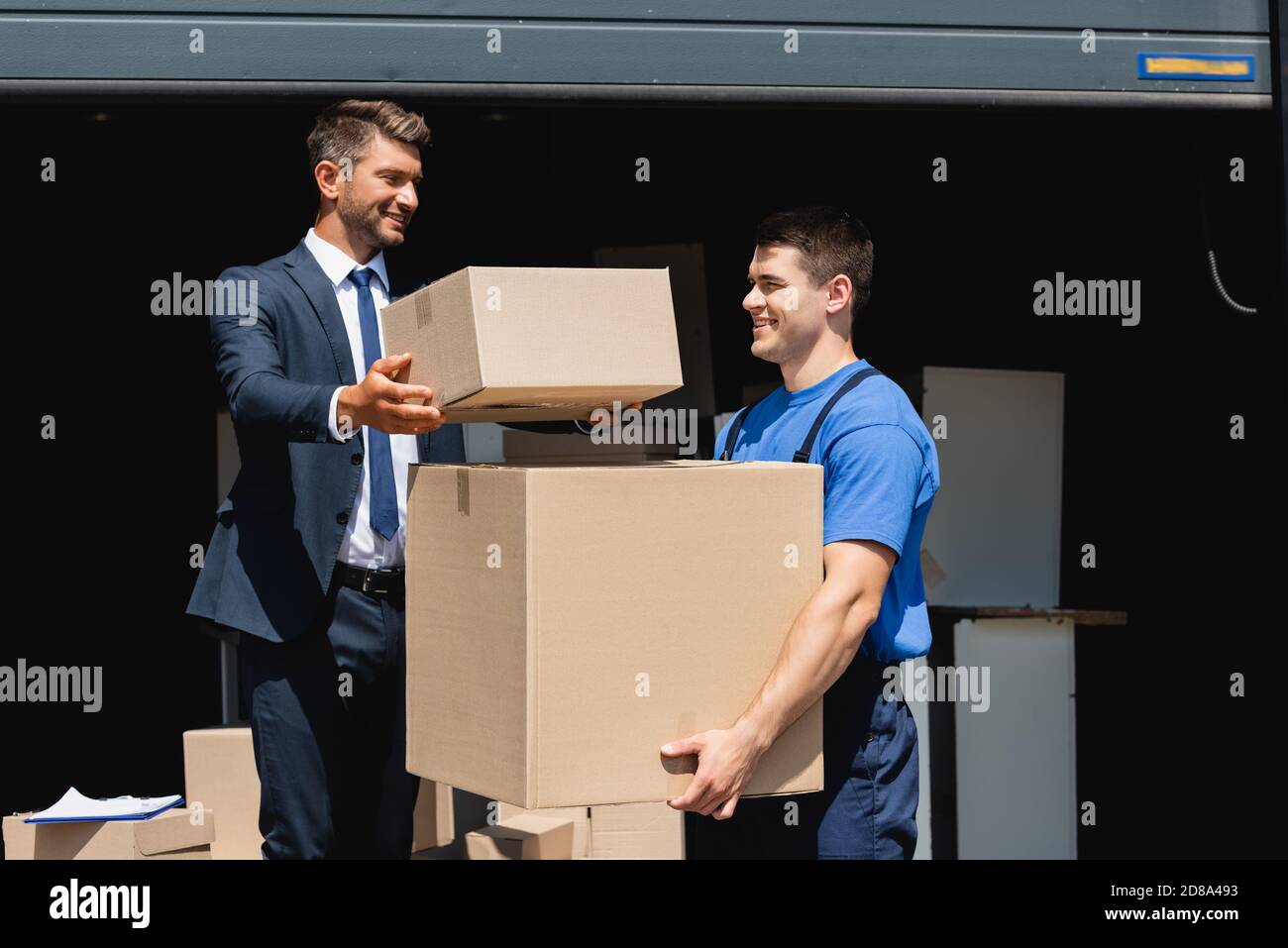 Delivery Man Hand Gloves Holding Package Stock Photo 2180509575