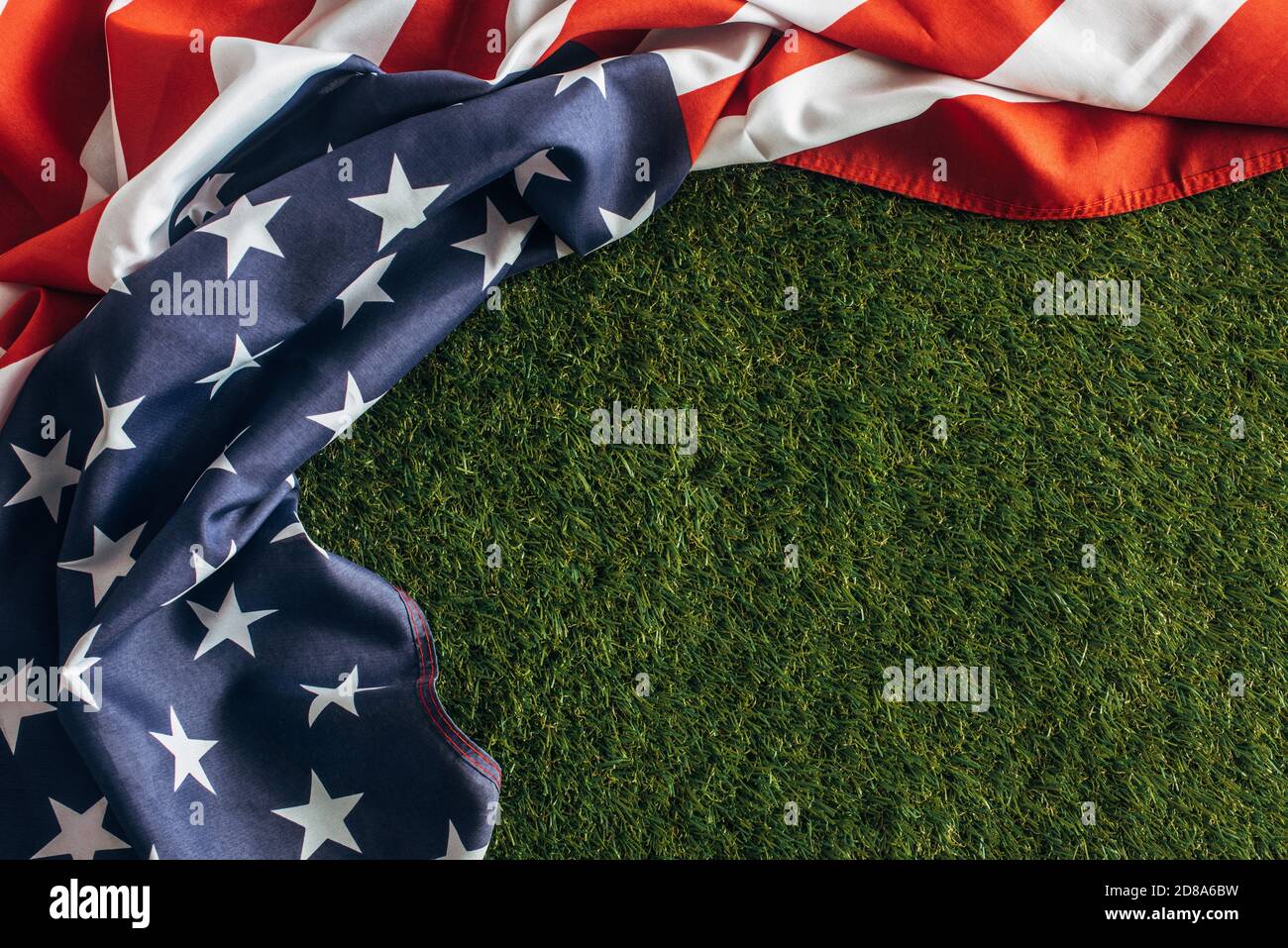 top view of american flag with stars and stripes on green grass outside, labor day concept Stock Photo