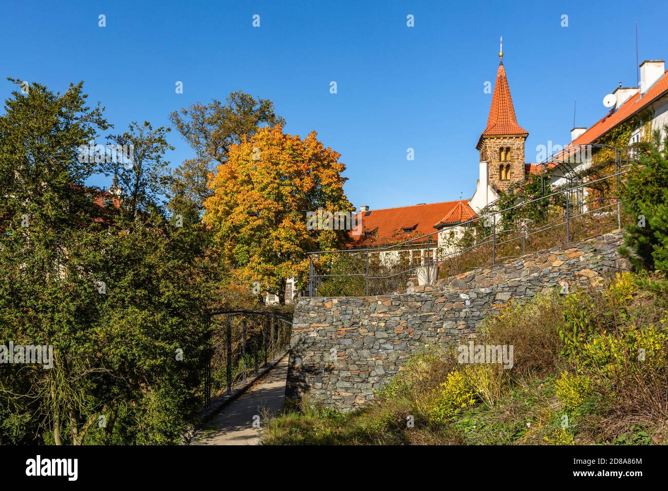 Pruhonice, Czech Republic - October 25 2020: View of the roman-gothic Church of the Birth of the Virgin Mary standing in a park with colorful trees. Stock Photo
