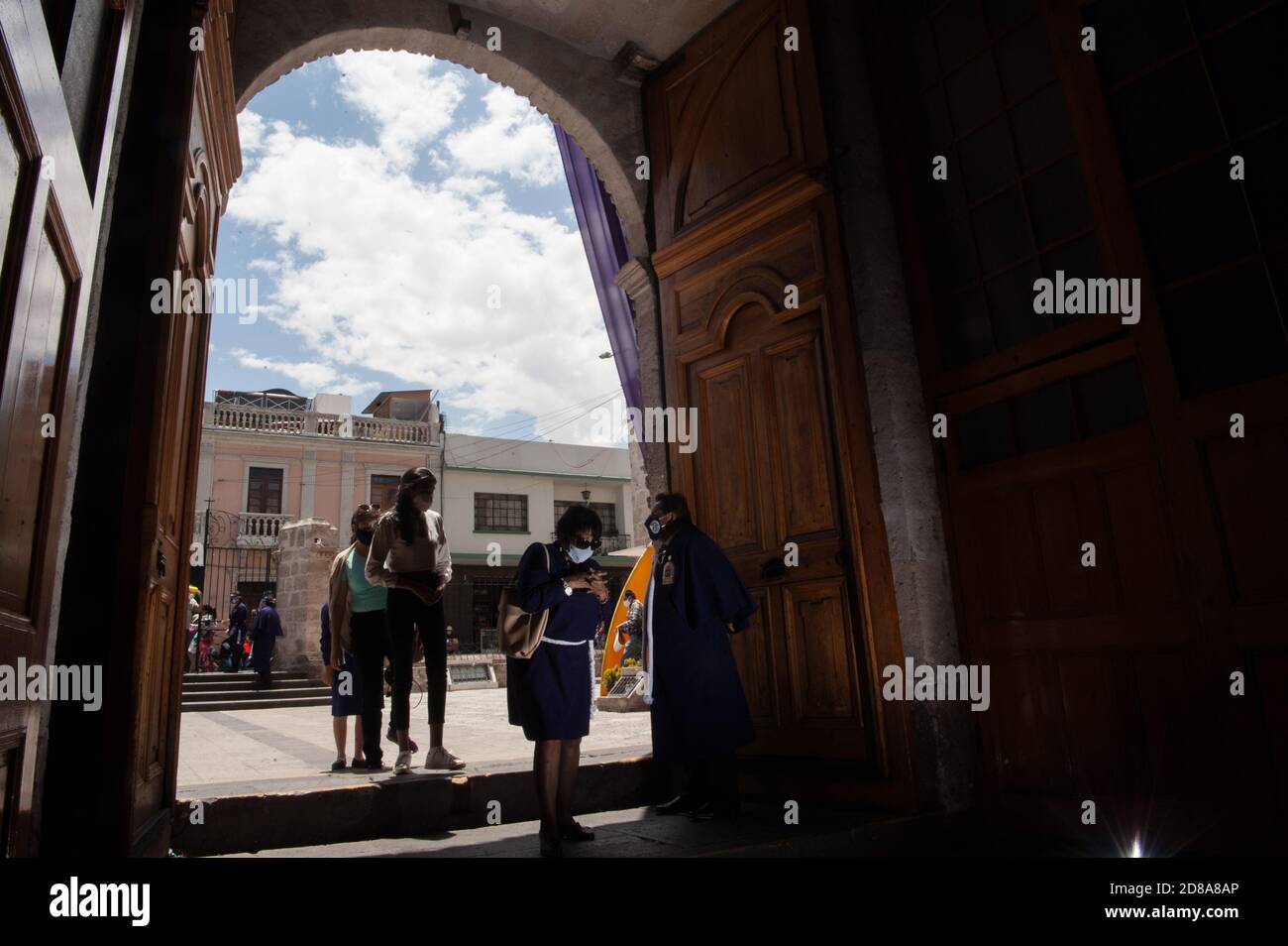 Believers in the 'Lord of Miracles' come to the temple of San Agustín (Arequipa) to pray to the image of the 'Purple Christ'. All health protocols wer Stock Photo