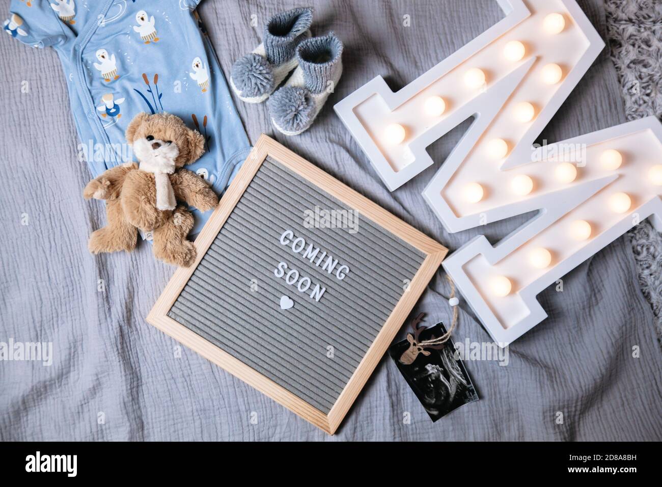 Coming soon sign. Baby announcement sign on a grey background. Coming soon concept. Stock Photo