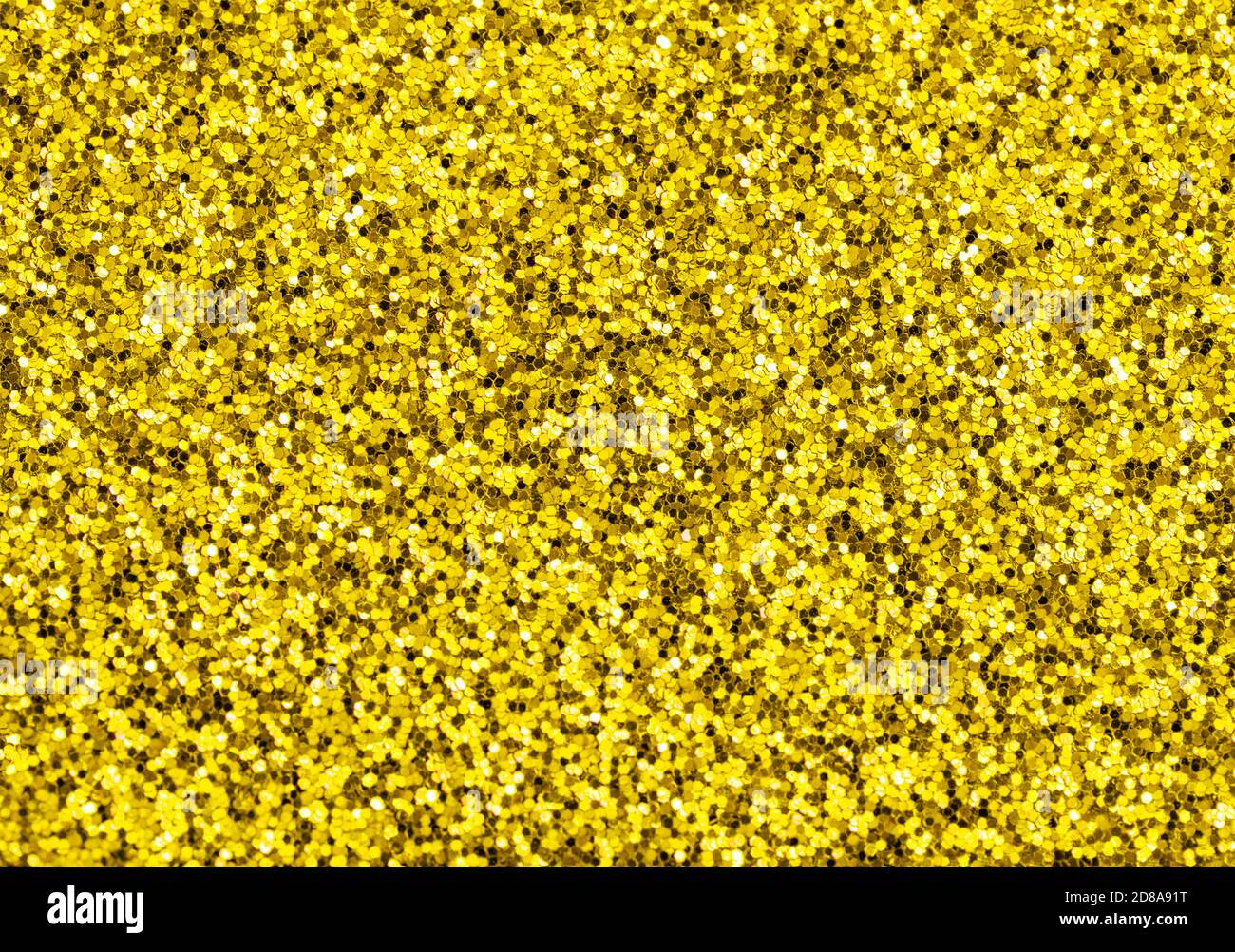 Shiny festive golden shimmer background texture. Glitter and glow Stock Photo