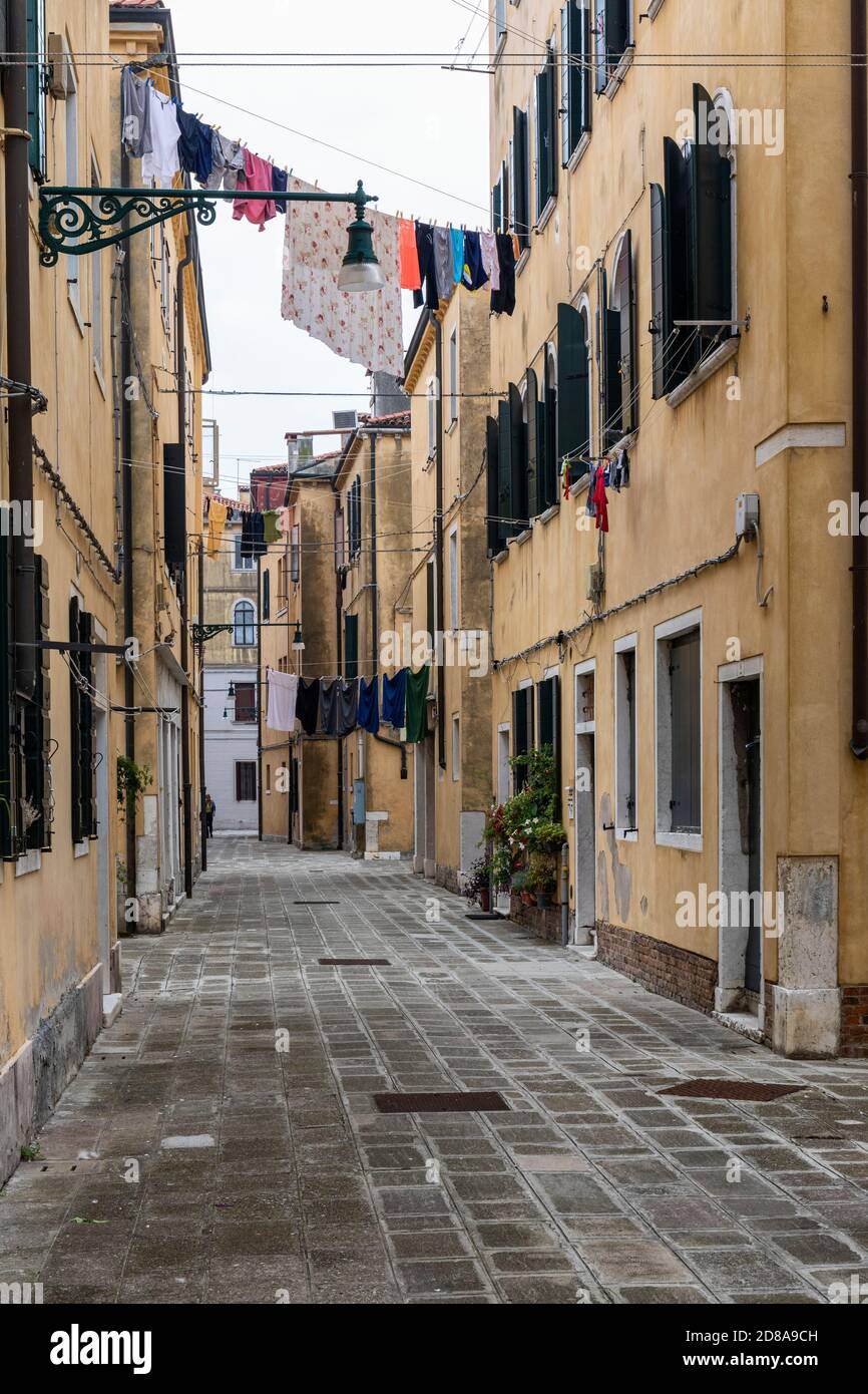 Washing hanging out to dry from homes in a narrow alley in the Castello region of Venice, Italy 2020 Stock Photo