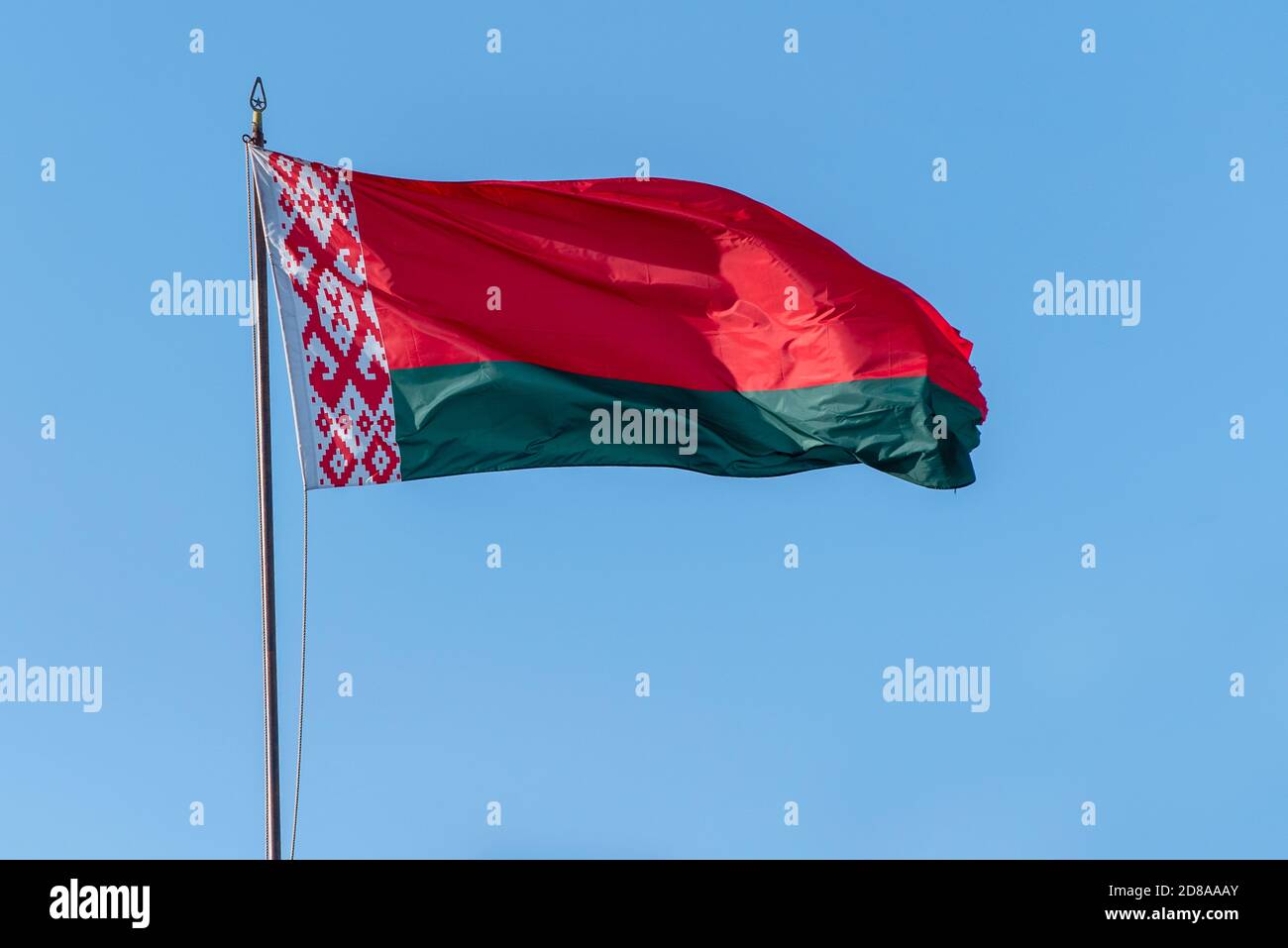 Flag of Belarus waving against blue sky Stock Photo