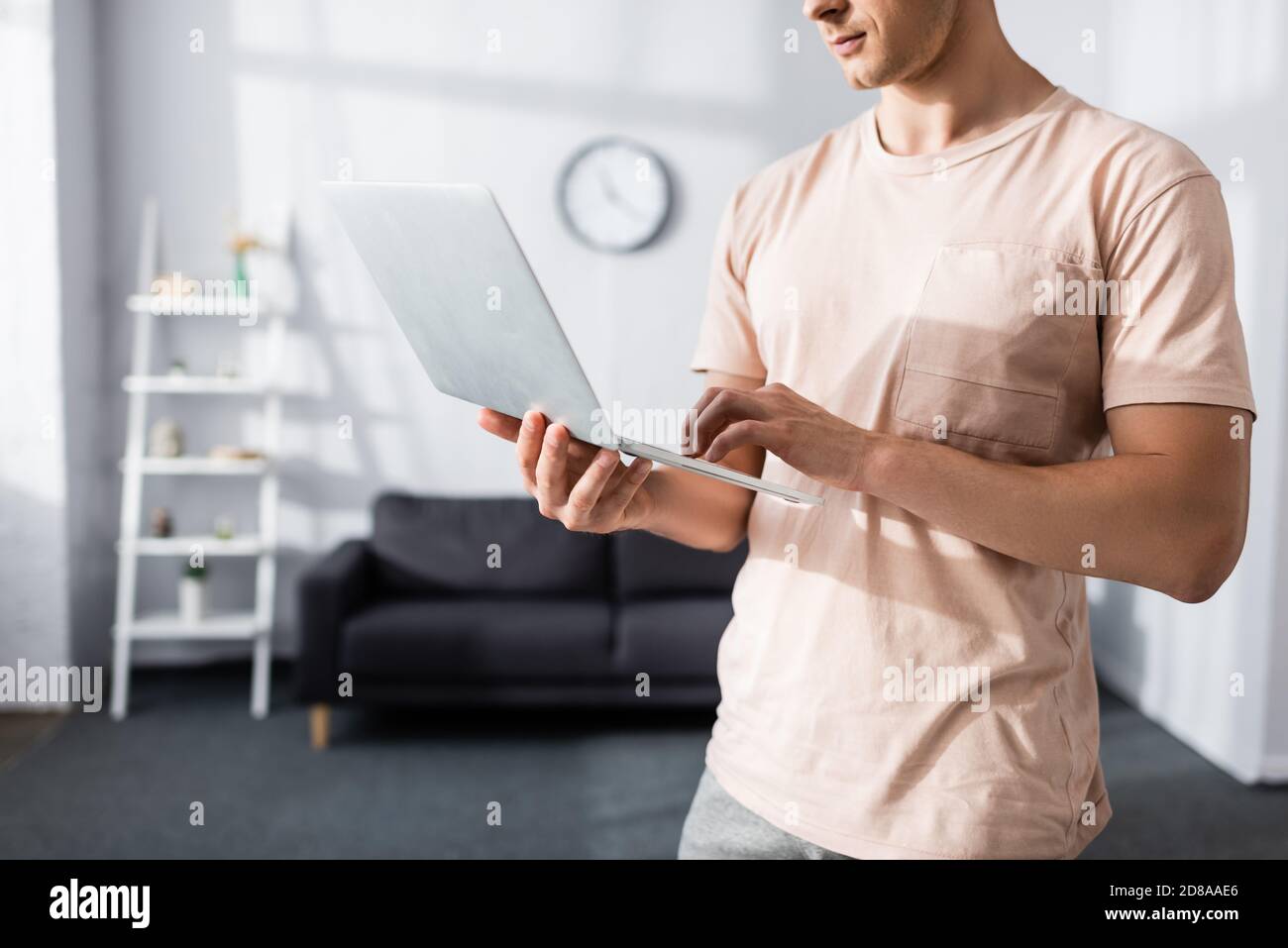 Cropped view of man using laptop at home, earning online concept Stock Photo