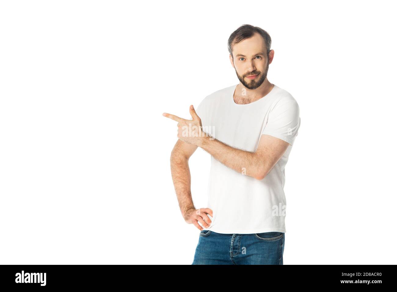 front view of smiling man with hand on hip pointing with finger aside isolated on white Stock Photo
