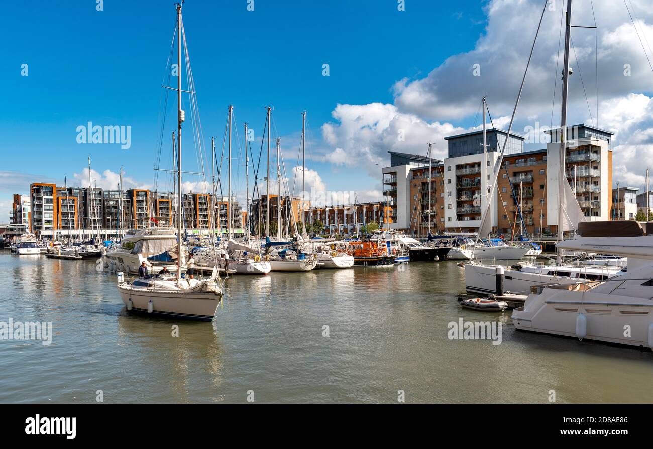 PORTISHEAD BRISTOL SOMERSET ENGLAND THE MARINA WITH A YACHT PASSING THE MOORED BOATS AND