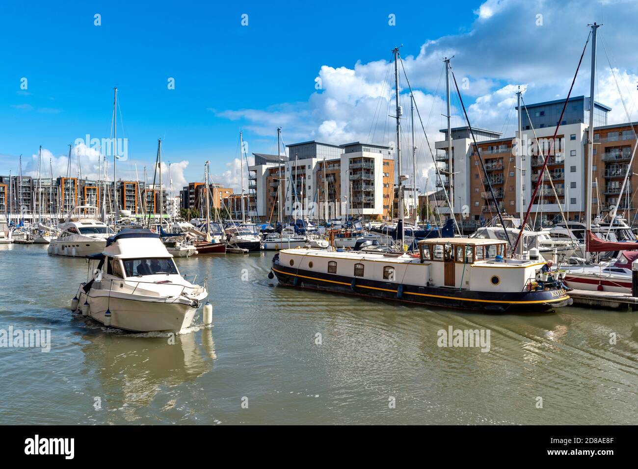 PORTISHEAD BRISTOL SOMERSET ENGLAND THE MARINA WITH SMALL BOAT PASSING THE MOORED YACHTS AND