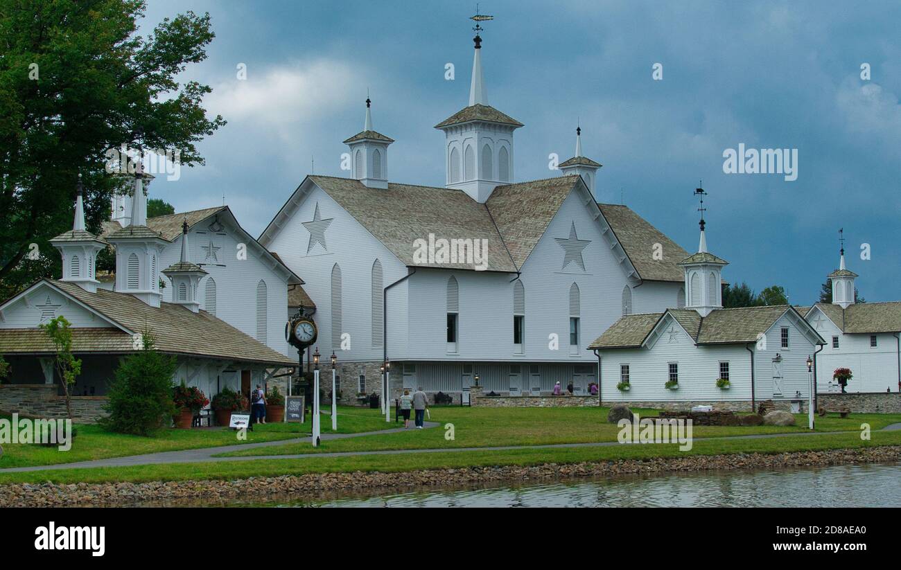 Old Restored White Barns with Cupolas and 5 Pointed Stars on a Cloudy Day Stock Photo