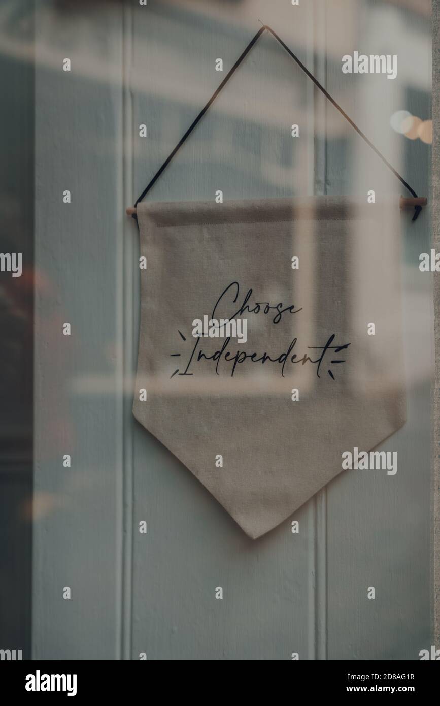 View through the window of Chose Independent sign inside a shop in Frome, Somerset, UK. Stock Photo