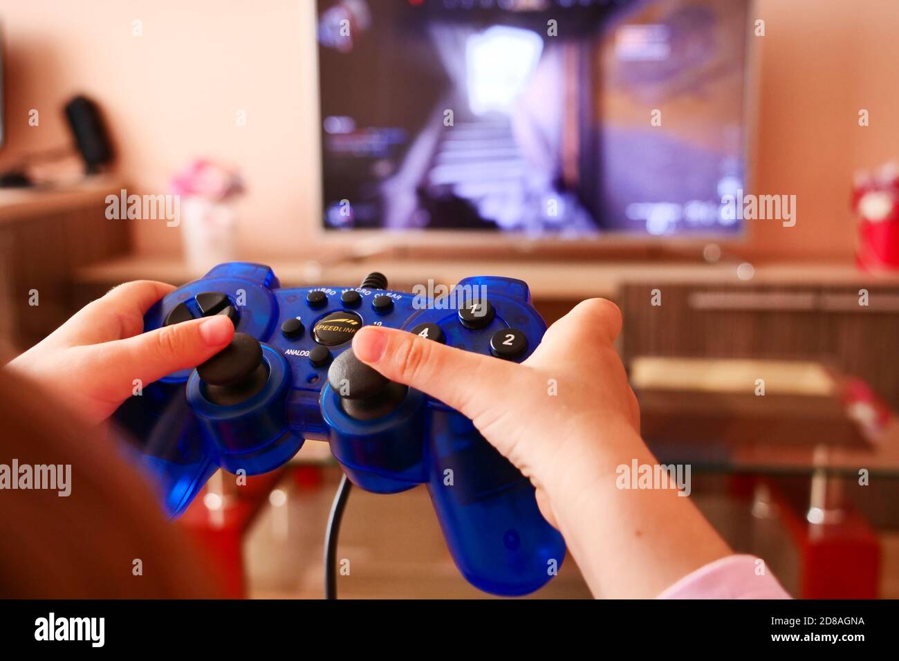 Children using a controller to play video games Stock Photo - Alamy