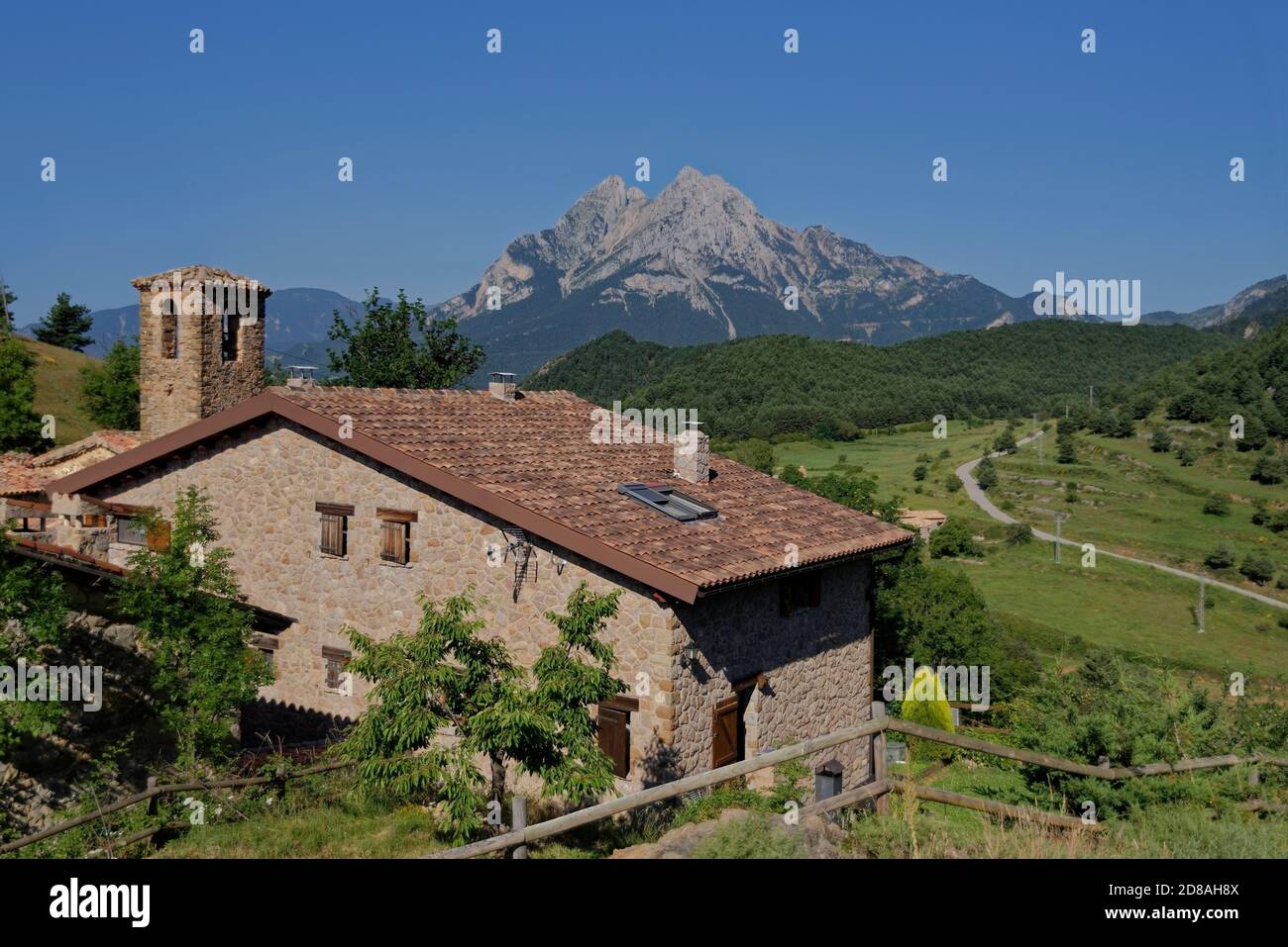 A house in a small town with Pedraforca mountain in the background. Stock Photo