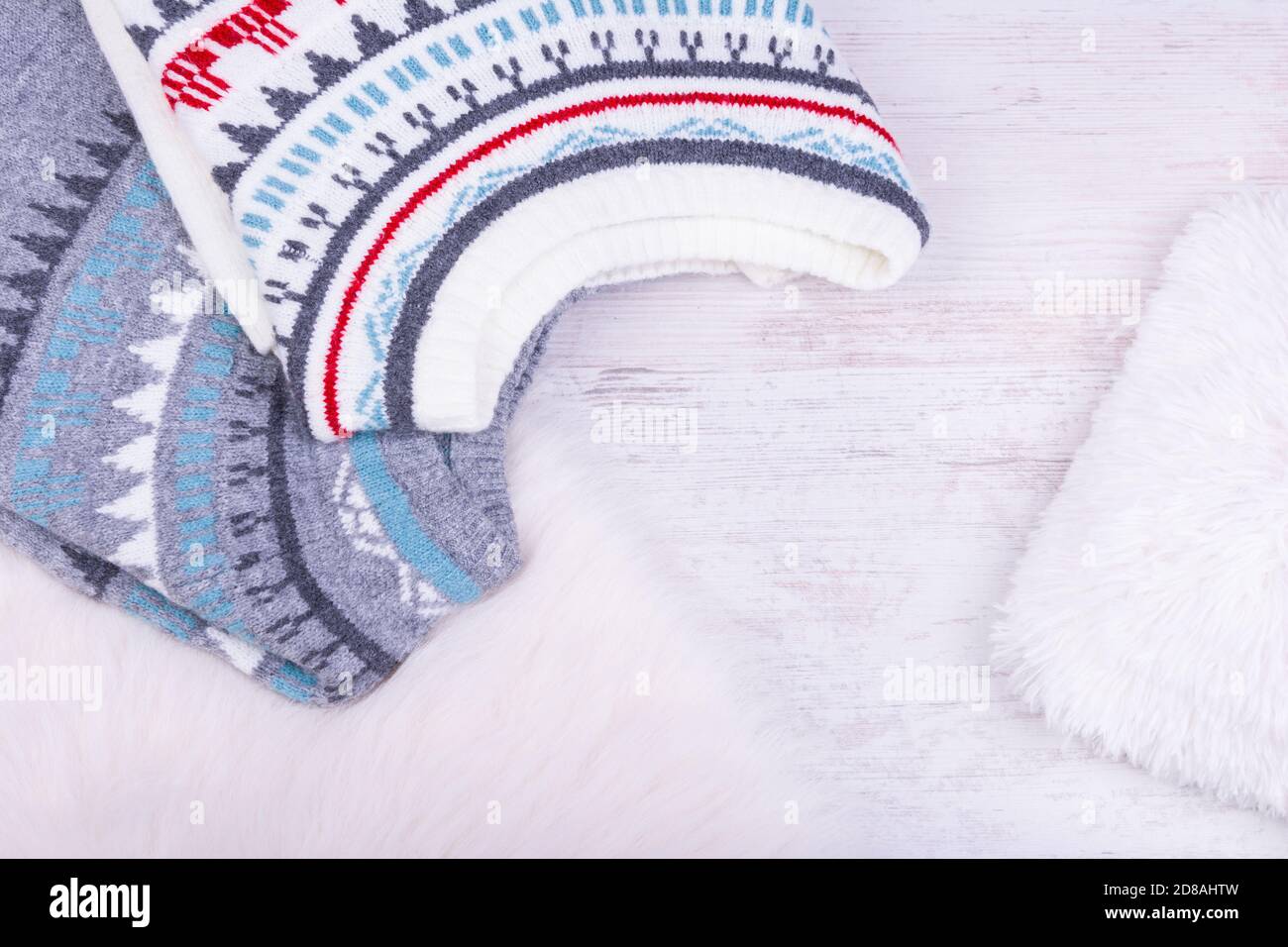 Warm winter knitted sweaters on white cozy background. Stock Photo