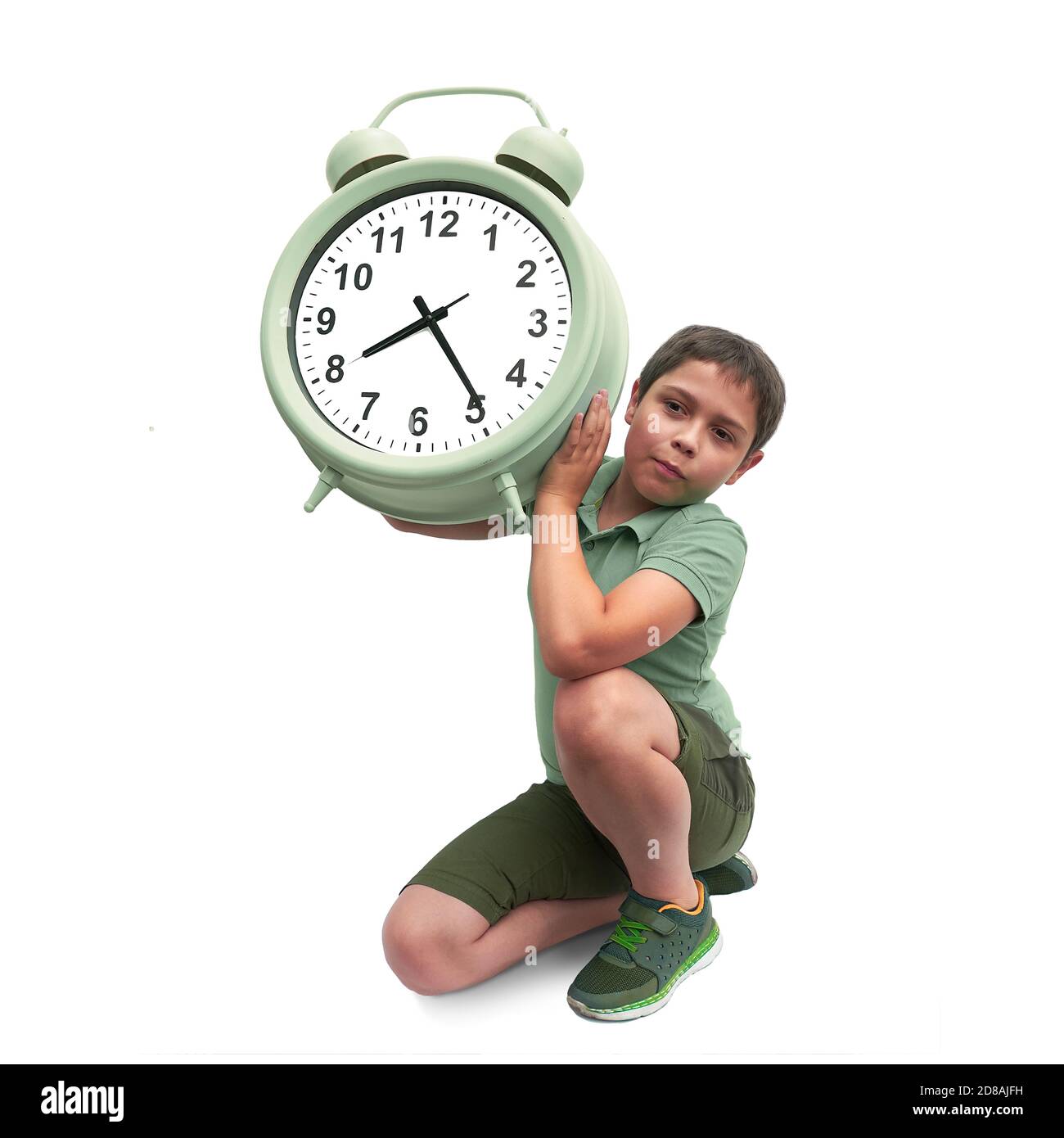 Schools start too early. Little boy with large alarm clock Stock Photo