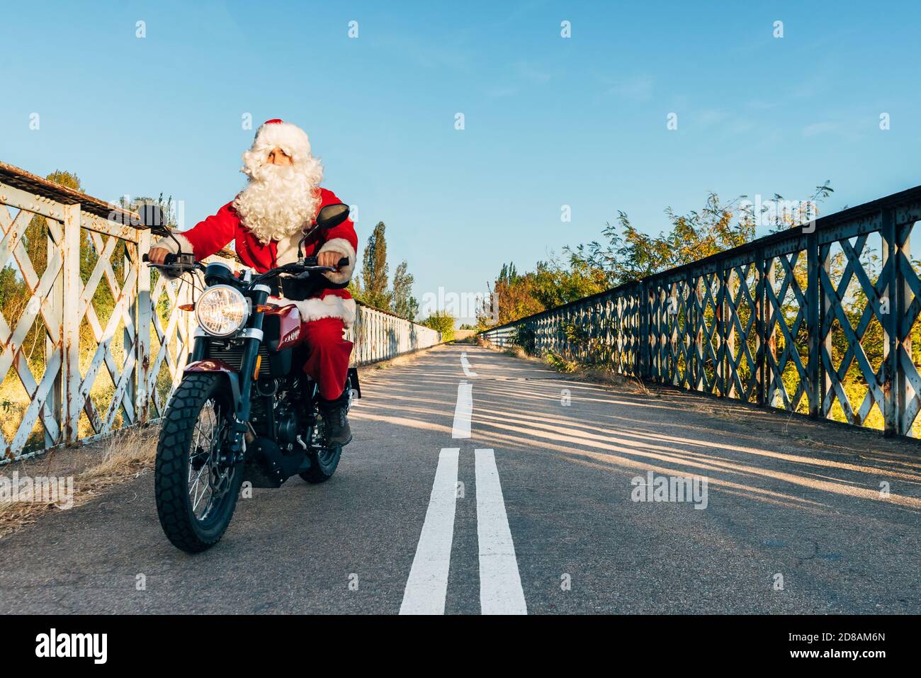 santa claus riding a motorcycle on the road Stock Photo