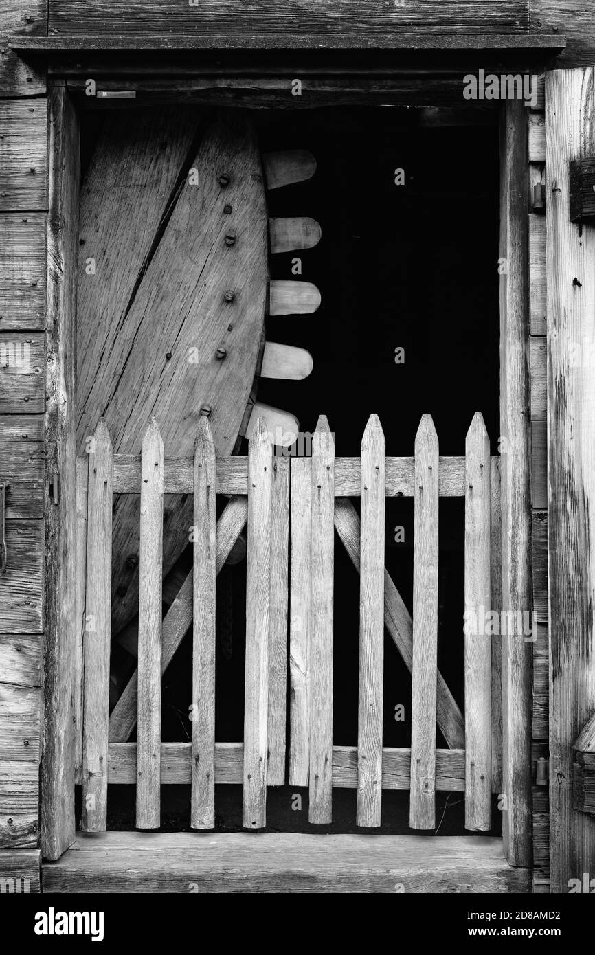 A large wood gear and gate block the front entrance to the Slitting House at the Saugus Iron Works. The Saugus Iron Works (originally named Hammersmit Stock Photo
