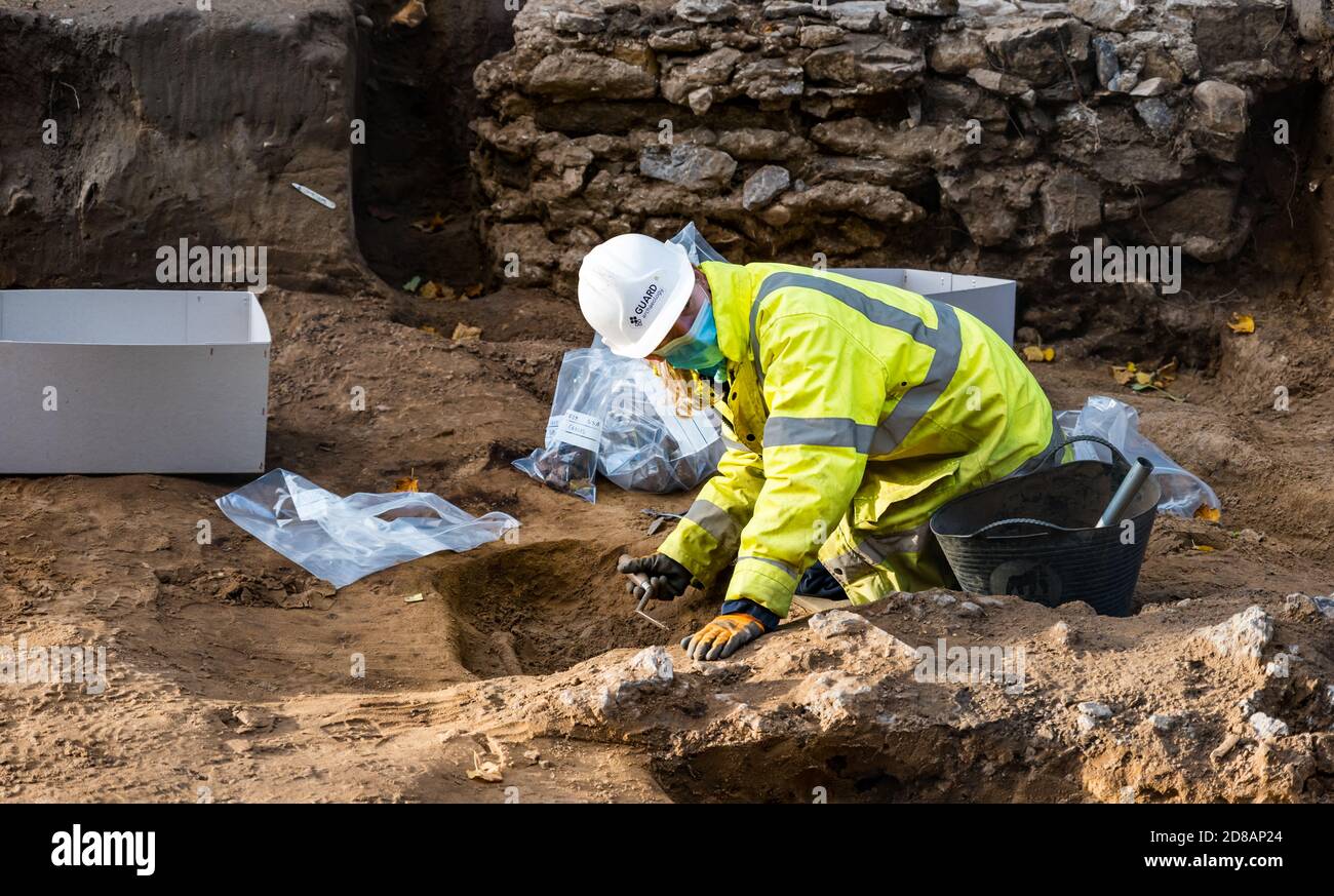 Archaeological dig of Medieval skeleton in burial site, Constitution Street, Leith, Edinburgh, Scotland, UK during tram line construction work Stock Photo