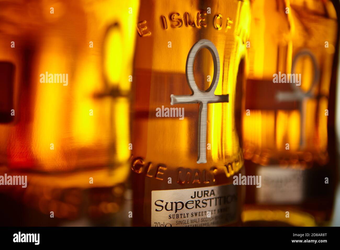 Rows of Whisky Bottles with golden light Stock Photo