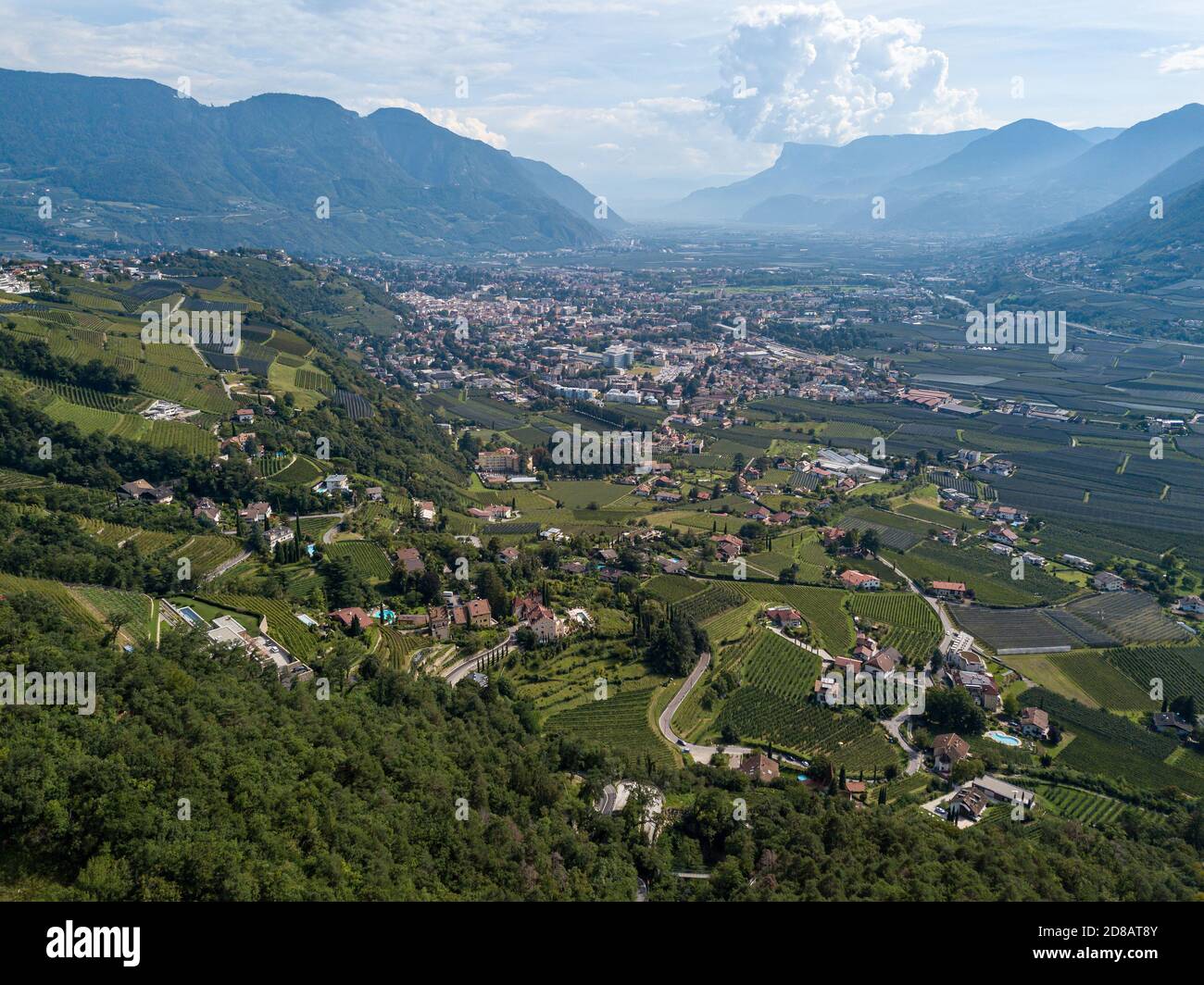 High angle view over the old South Tyrolean city of Merano / Meran and the surrounding valleys of Tyrol on a cloudy summer day Stock Photo