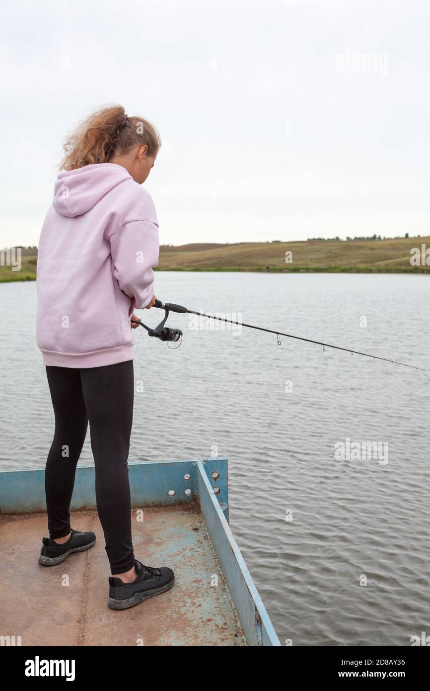 Young girl fish rod fish hi-res stock photography and images - Alamy