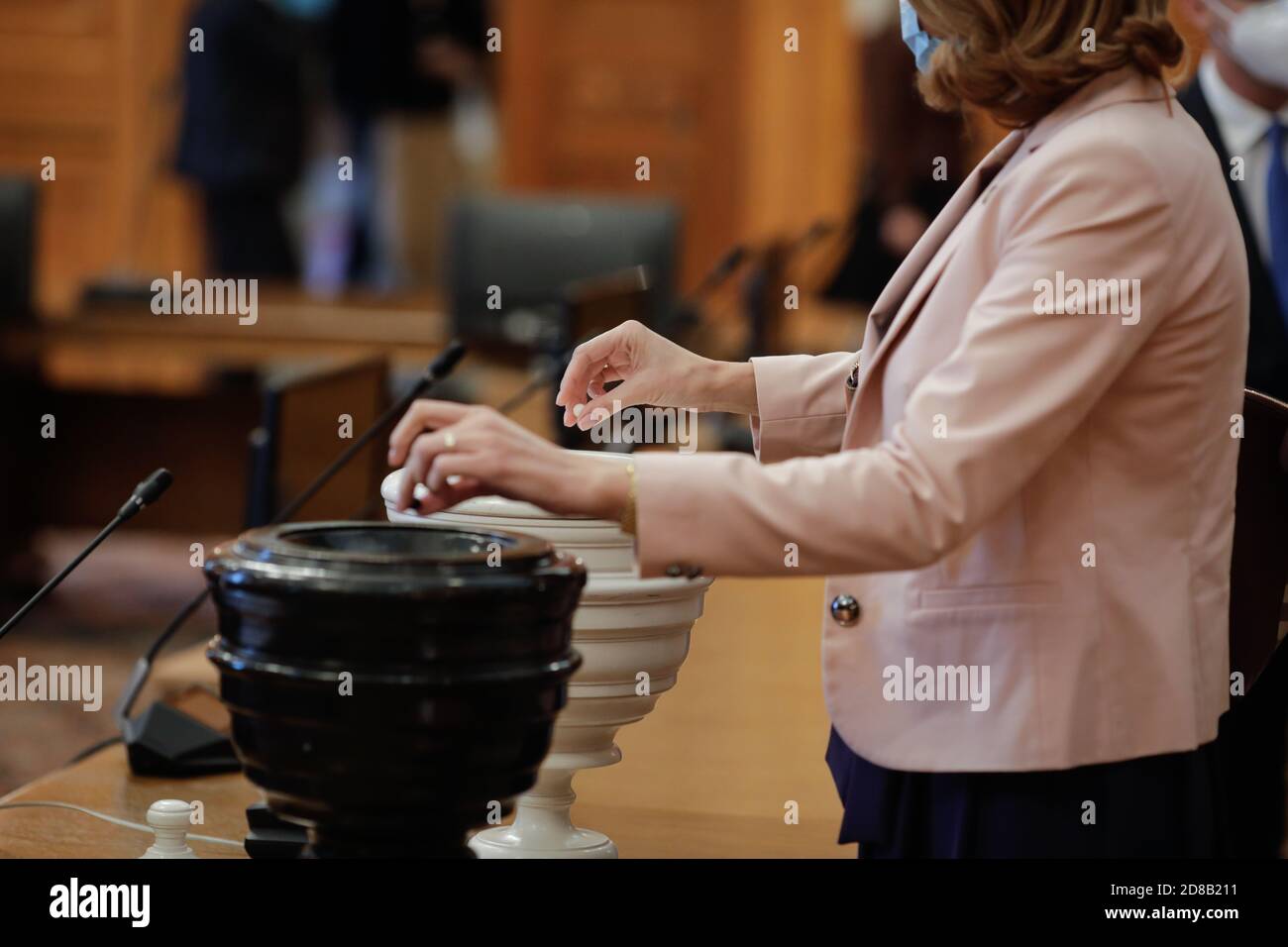 Bucharest, Romania - October 27, 2020: Details with Romanian woman MPs casting a secret vote with black and white balls (Blackballing) in black and wh Stock Photo