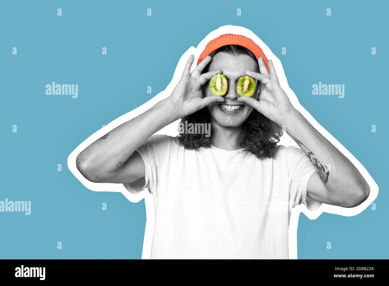 Young adult man covered eyes with kiwi Stock Photo