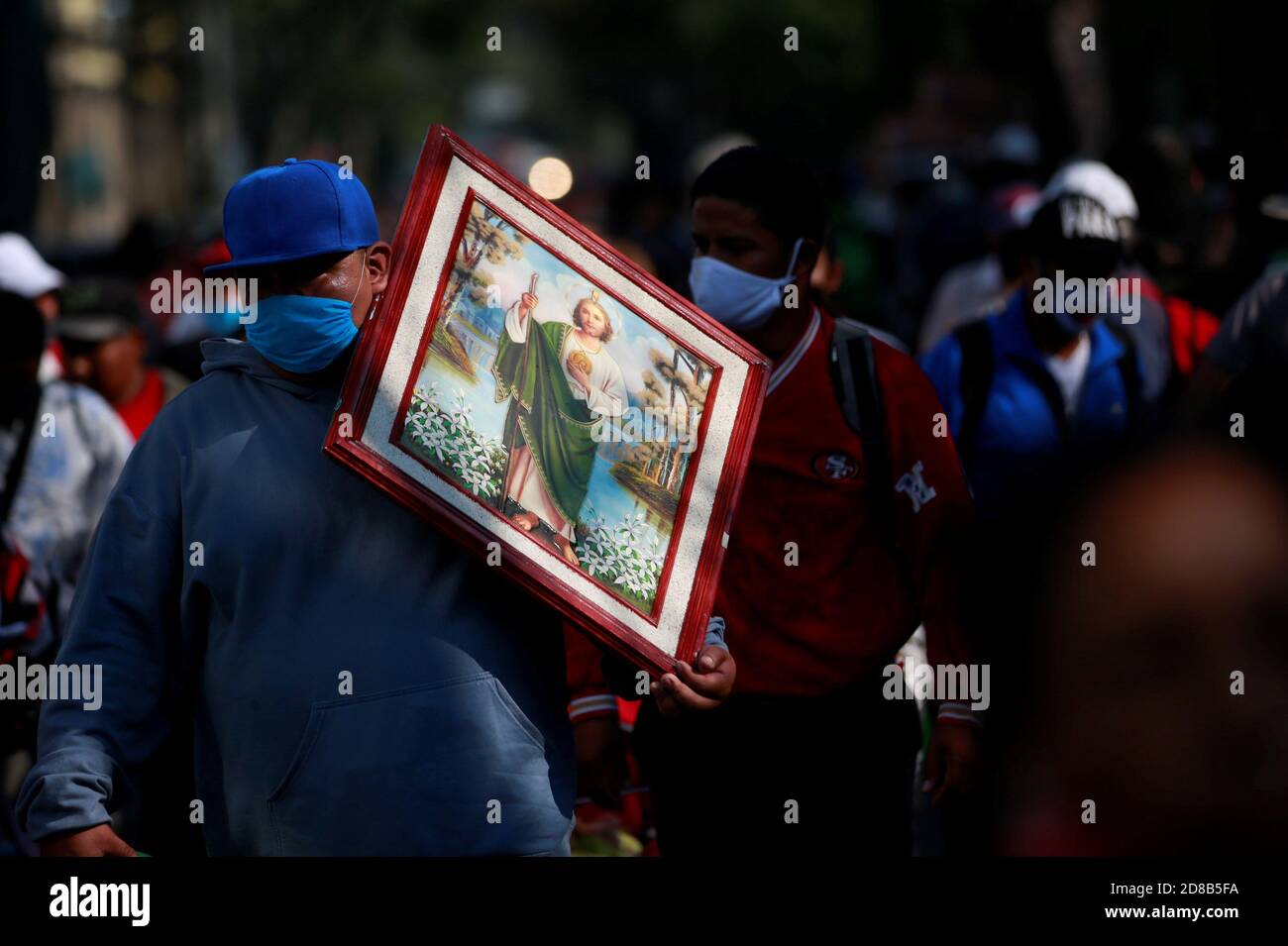 A follower of San Judas Tadeo carries a Tadeo frame as he and others visit the San Hipolito church for San Judas annual celebration, as the coronavirus disease (COVID-19) outbreak continues in Mexico City, Mexico October 28, 2020. REUTERS/Carlos Jasso Stock Photo