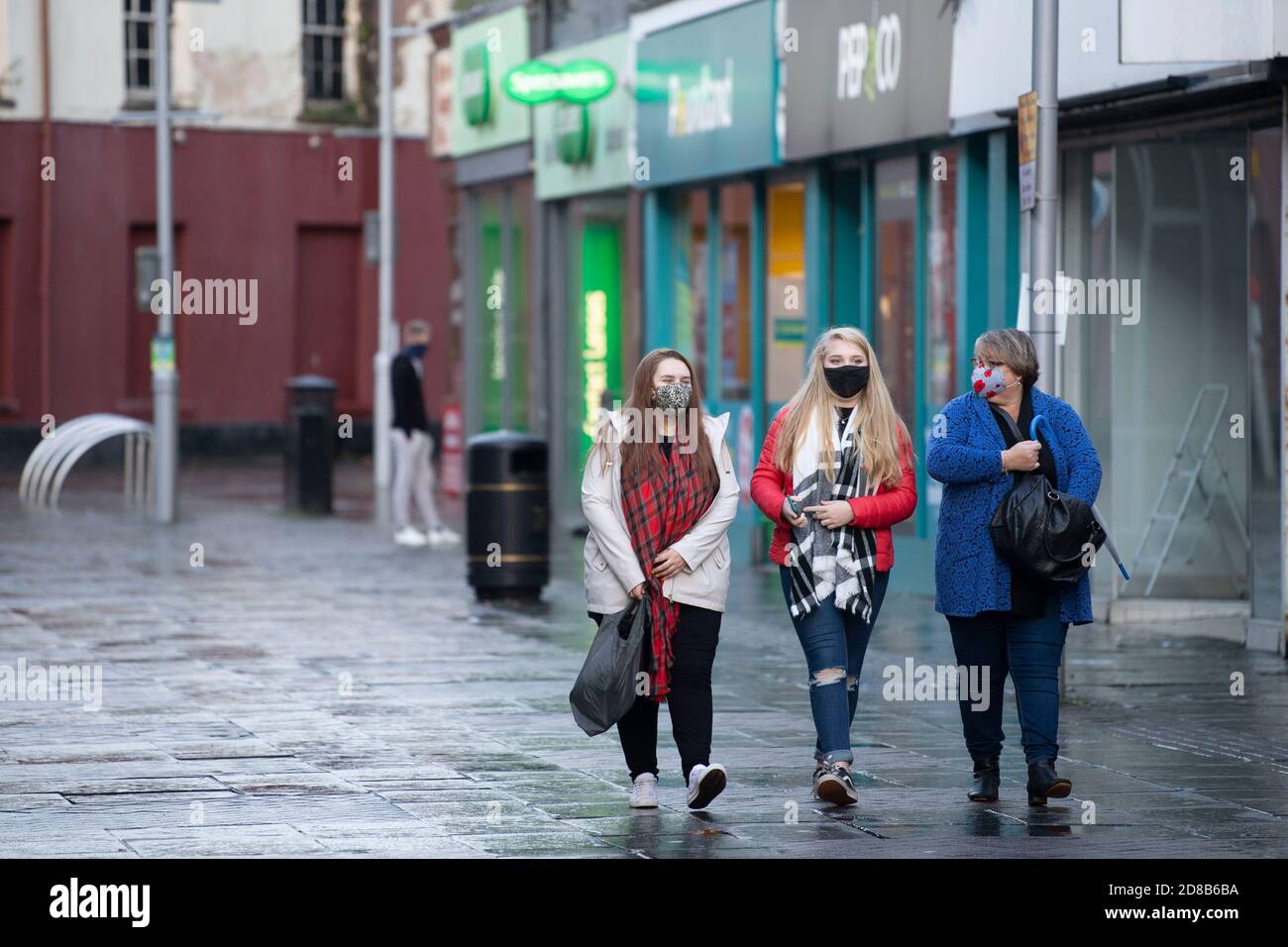 BRIDGEND, WALES - OCTOBER 28: Three women walk through the town centre ...