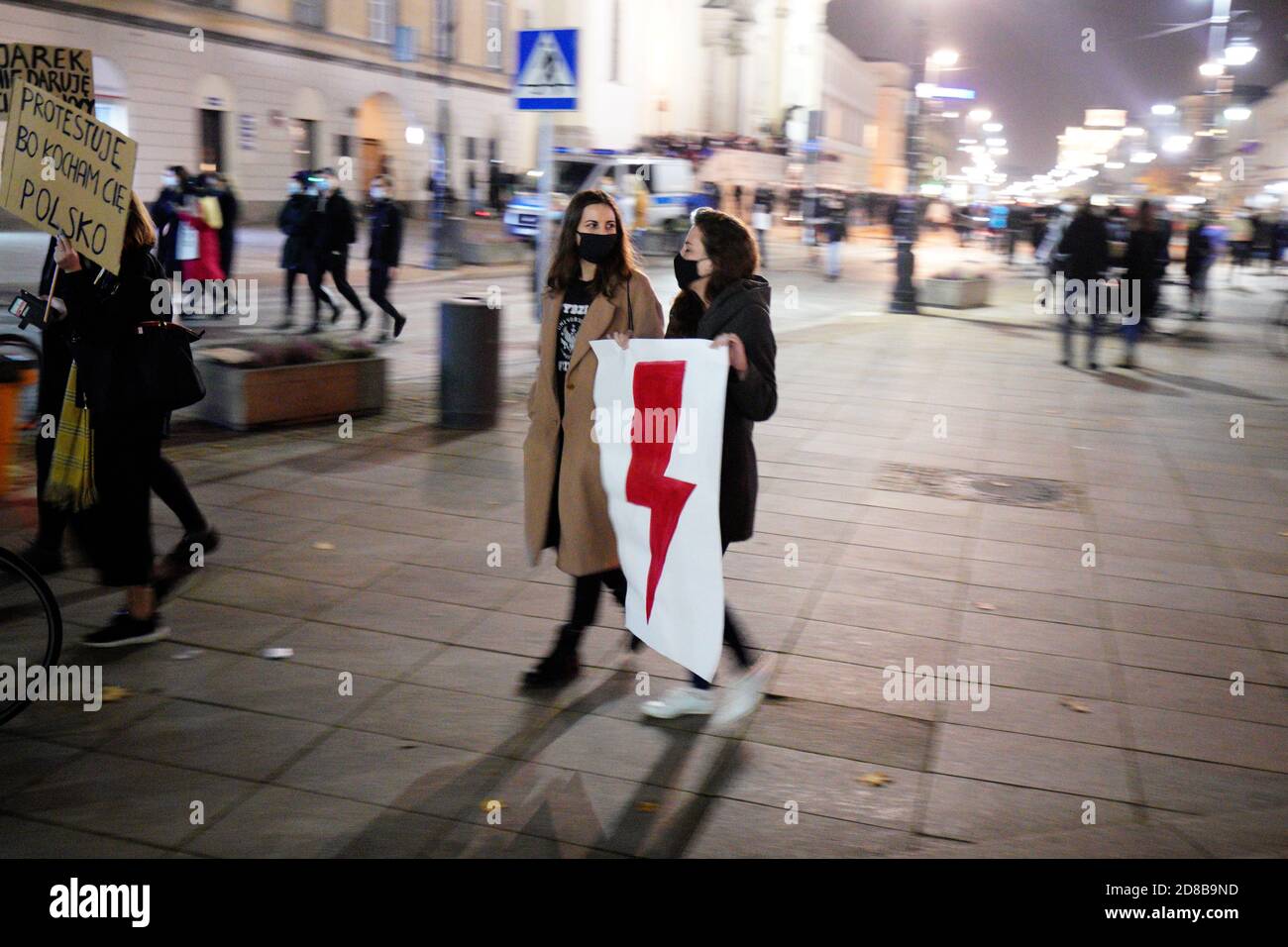 A woman carries a sign with a red lightning bolt, a symbol of the women's strike movement during a demonstration in Warsaw, Poland on October 28, 2020. In reaction to last week's ruling by the Constitutional Tribunal banning resulting in a near-total ban on abortions in Poland women across the country have been called to go on strike on Wednesday. Today's strike marks the 7th consecutive day of pro-choice protests against the right-wing, Law and Justice controlled government with it's close ties to the Catholic church. Poland's de facto leader and head of the Law and Justice party Jaroslaw Kac Stock Photo