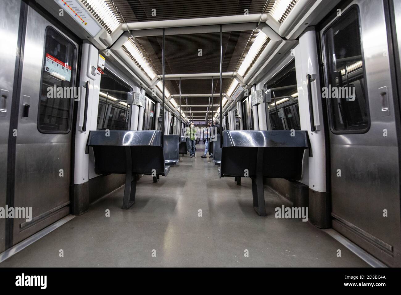 2020.10.28. Barcelona, Spain. 22:40 h. In an almost empty subway lane a few people travel during the first hours of that day's curfew. © Aitor Rodero. Stock Photo