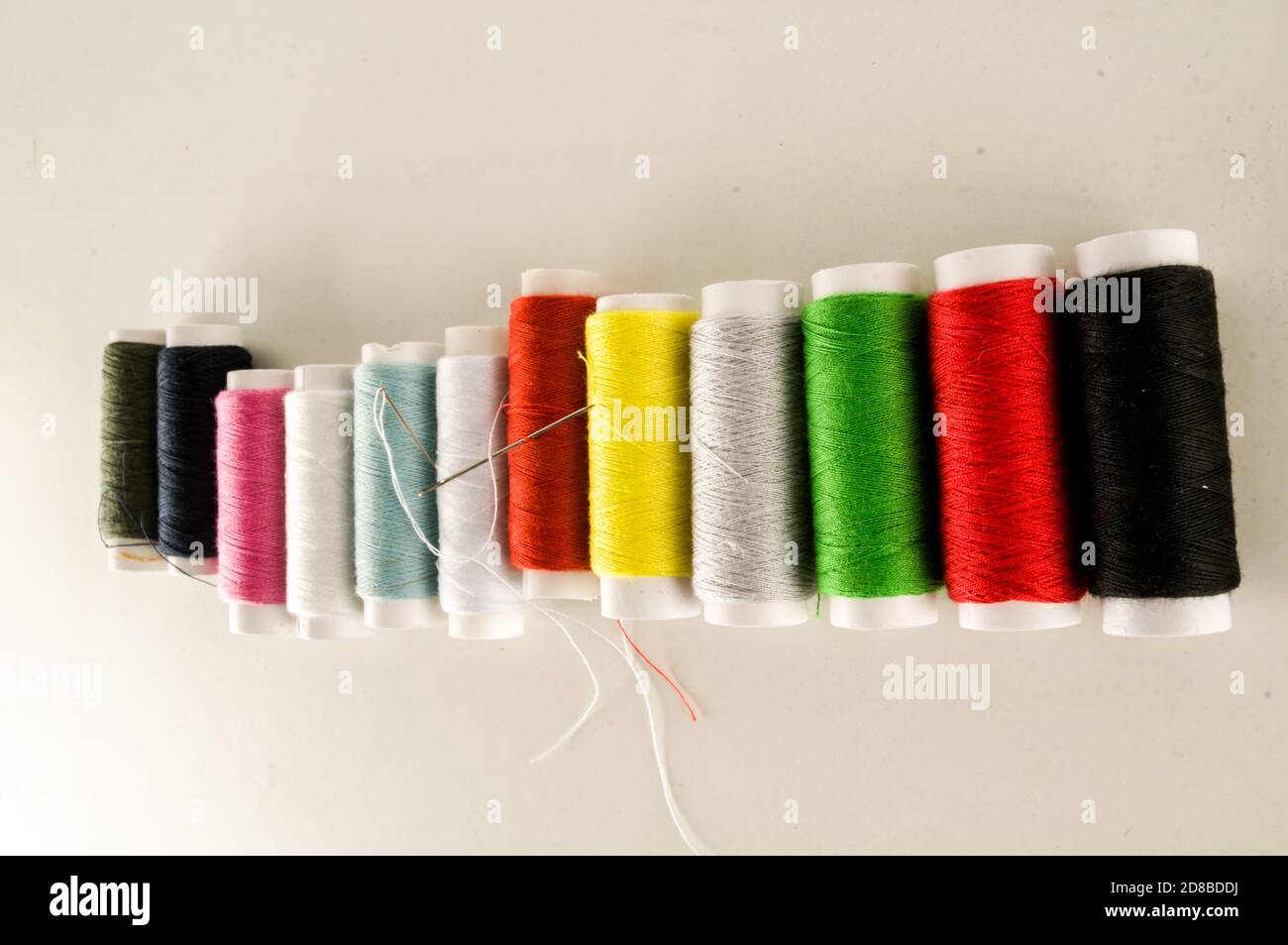 Colored sewing thread background Stock Photo - Alamy