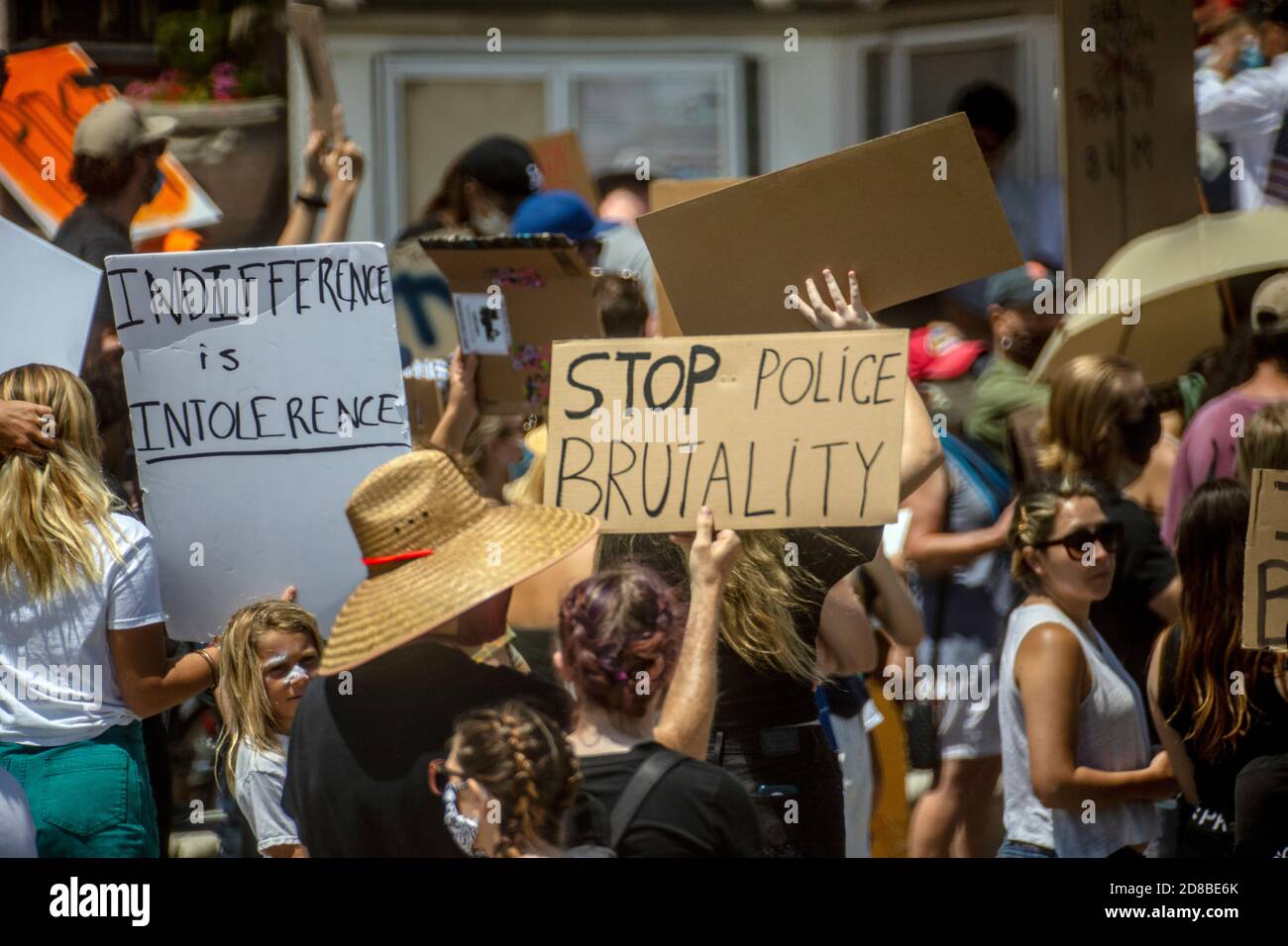 Wearing face masks due to coronavirus, a Black Lives Matter demonstration carries signs in Newport Beach, CA. Stock Photo