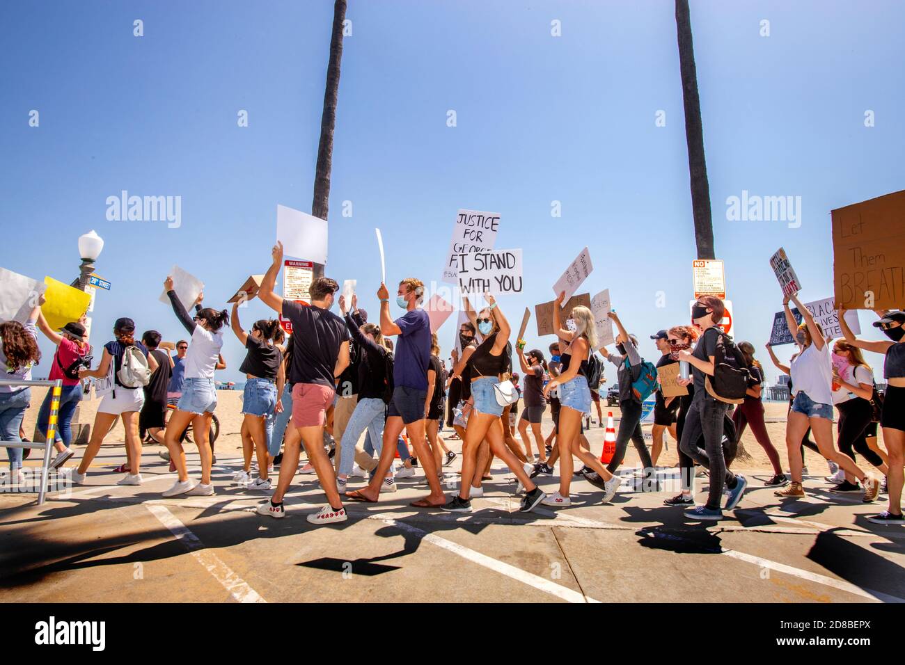 Wearing face masks due to coronavirus, a Black Lives Matter demonstration carries signs in Newport Beach, CA. Stock Photo