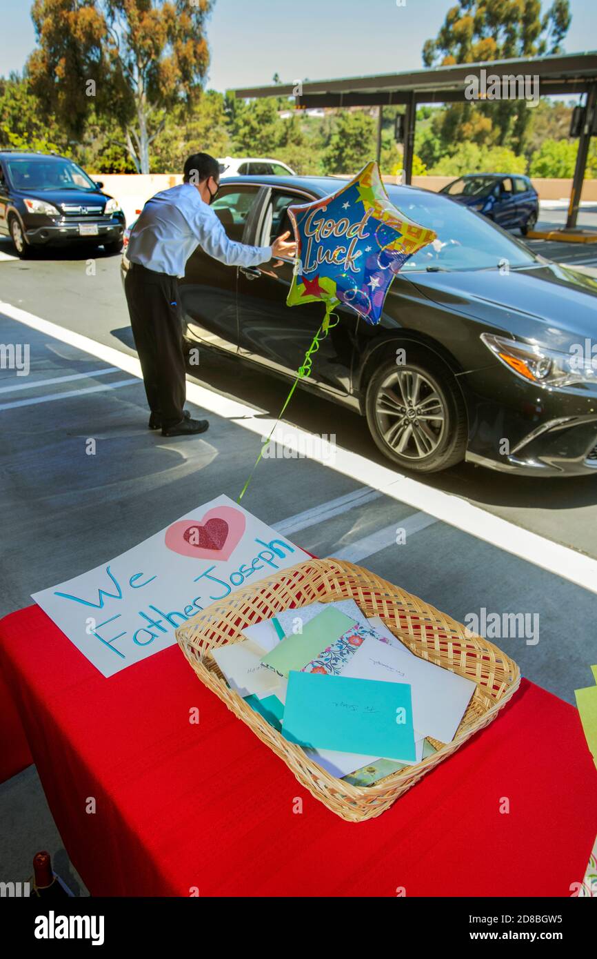 Due to the coronavirus pandemic,parishioners at a Southern California Catholic church use a drive through ceremony to bid farewell to a departing Asia Stock Photo