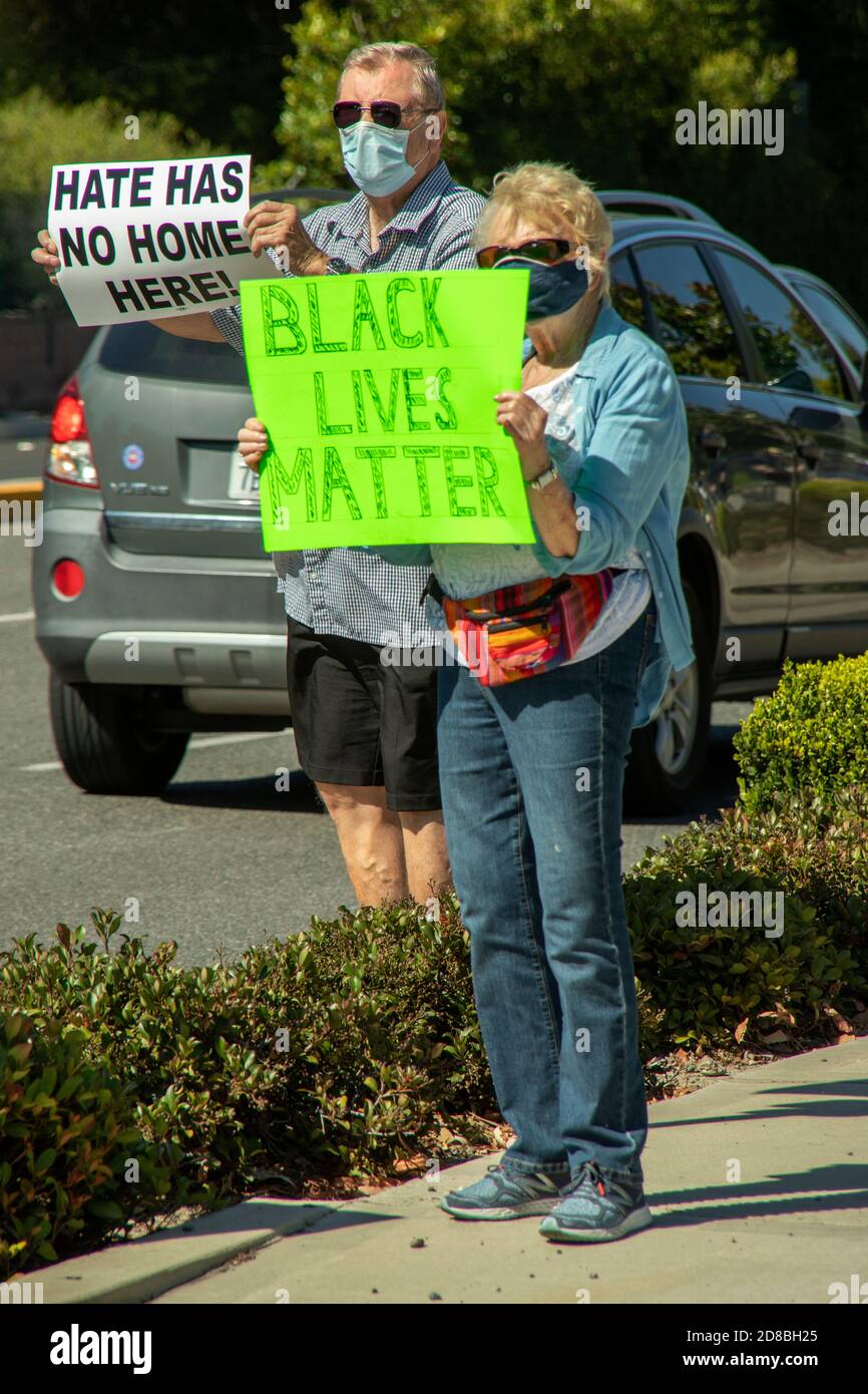 Retired residents wear masks due to the coronavirus pandemic as they hold a silent demonstration in favor of the Black Lives Matter movement in Laguna Stock Photo