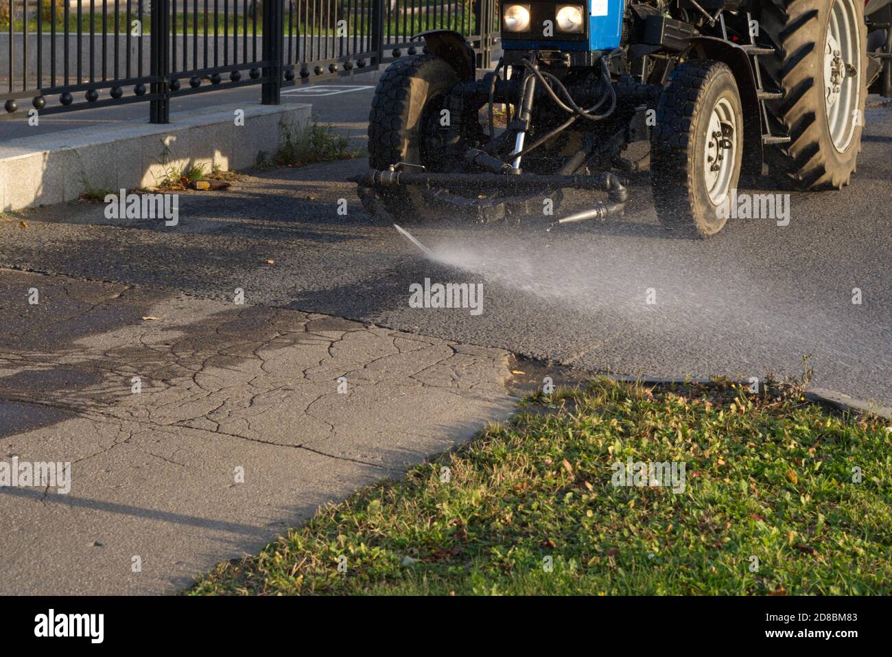 the tractor washes the asphalt in the pedestrian zone Stock Photo
