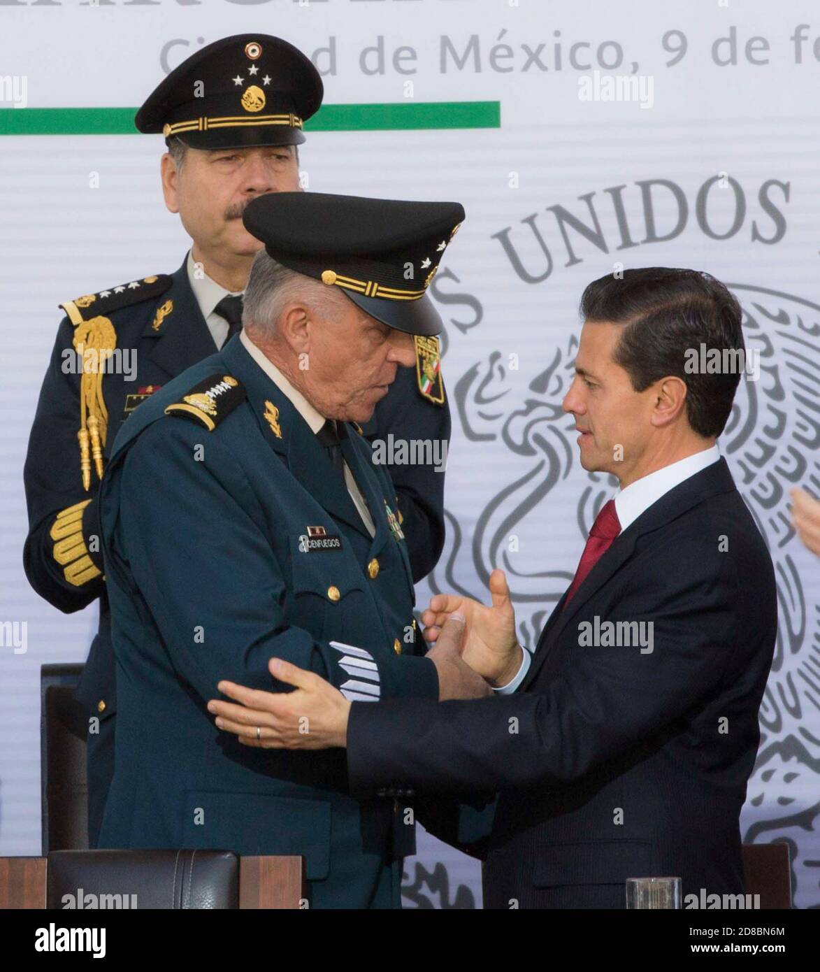Mexican President Enrique Pena Nieto, right, embraces Defense Minister Gen. Salvador Cienfuegos Zepeda during a ceremony marking the 104th Anniversary of the Loyalty March February 9, 2017 in Mexico City, Mexico. Cienfuegos was arrested October 16, 2020 at Los Angeles International Airport and charged with drug-related corruption. Stock Photo