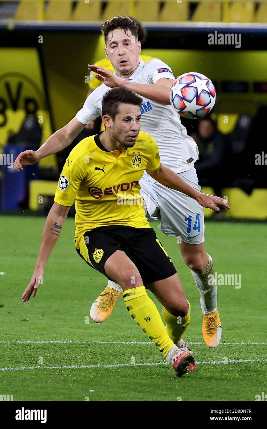 Dortmund, Germany. 28th Oct, 2020. Raphael Guerreiro (front) of Dortmund vies with Daler Kuzyayev of Zenit during the UEFA Champions League Group F football match between Borussia Dortmund and FC Zenit in Dortmund, Germany, Oct. 28, 2020. Credit: Joachim Bywaletz/Xinhua/Alamy Live News Stock Photo