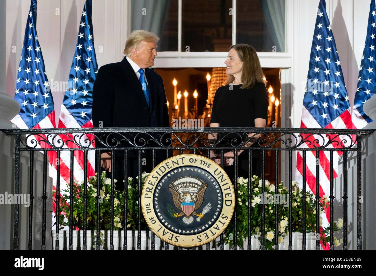 U.S President Donald Trump applauds U.S. Supreme Court Associate Justice Amy Coney Barrett from the Blue Room Balcony of the White House October 26, 2020 in Washington, DC. Stock Photo